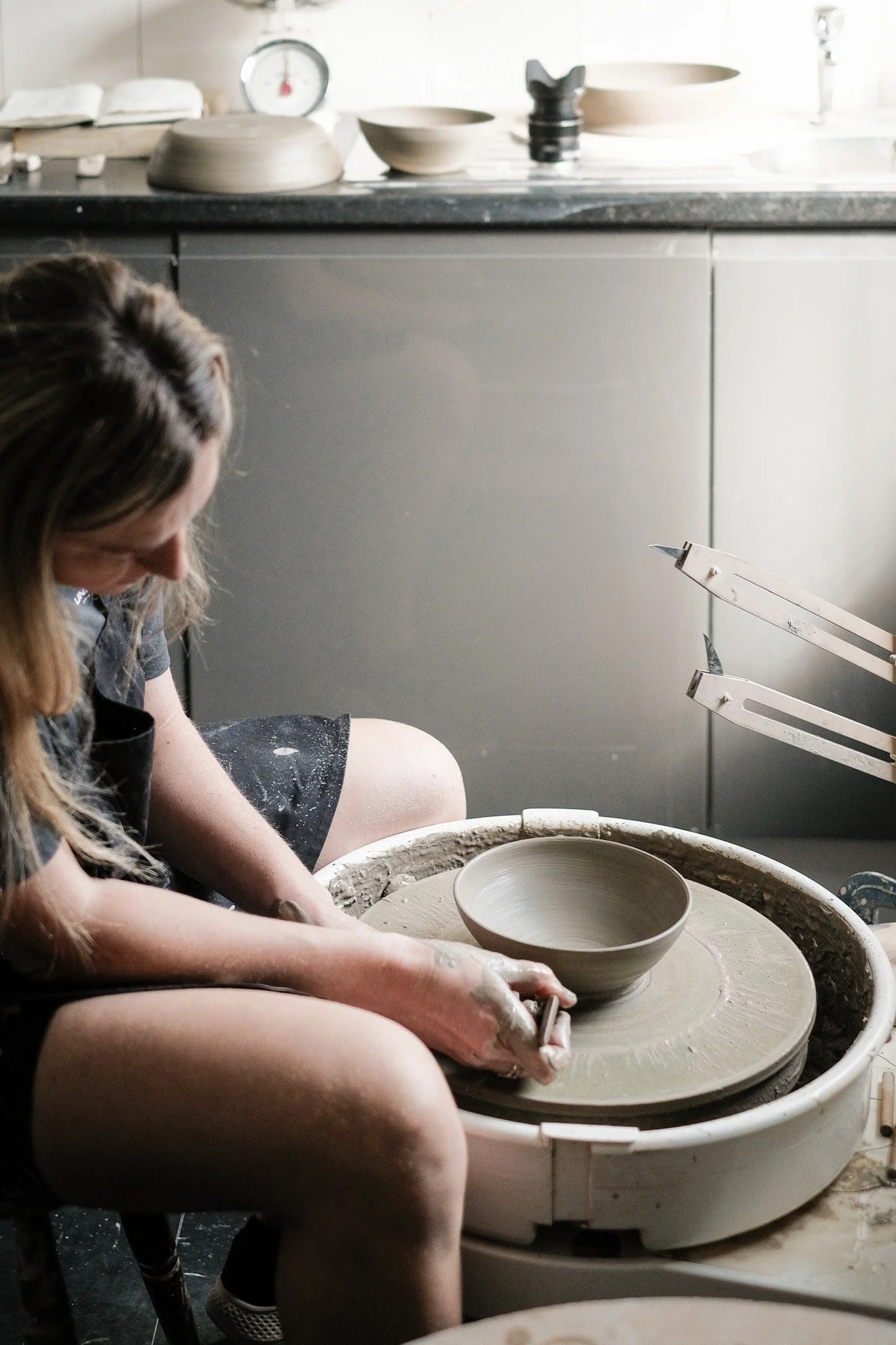 Emma, working at the potters wheel in her Macclesfield pottery studio