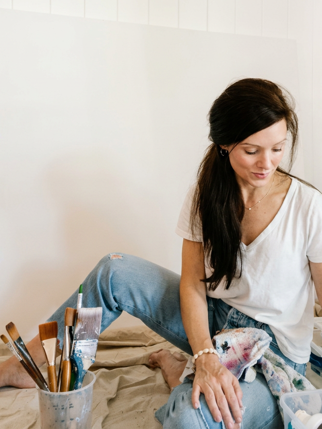 Artist Shannon D'Alton in her studio surrounded by art supplies