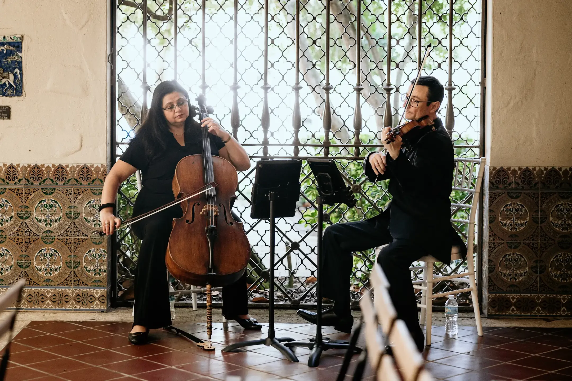 Sunset Strings violinist and cellist performing in a Museum of Fine Arts courtyard in St. Petersburg.