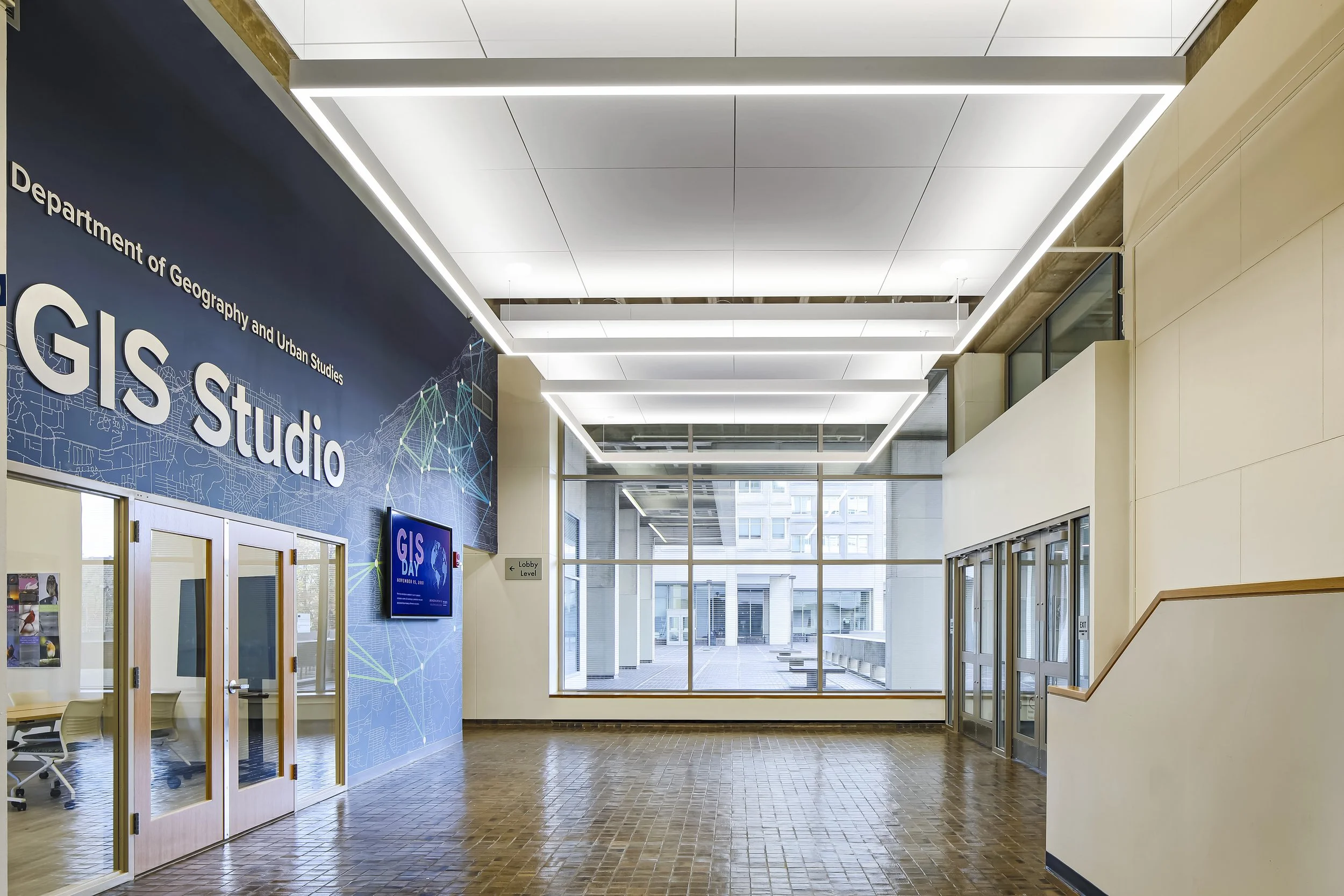 Include description of image here. For example, interior lobby of the Gladfelter Hall at Temple University featuring an entrance to the Science Lab.