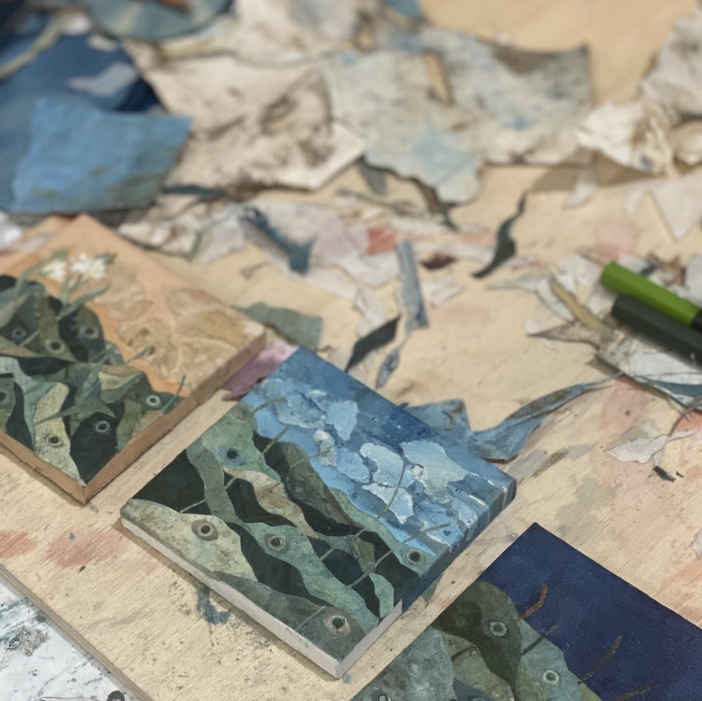 I like working on tiny pieces on a big table piled with paper scraps. It's a delightful mess full of potential discovery.