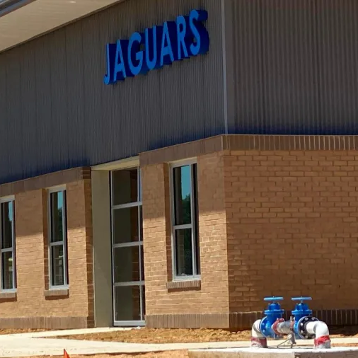 Modern school campus with lawn and trees