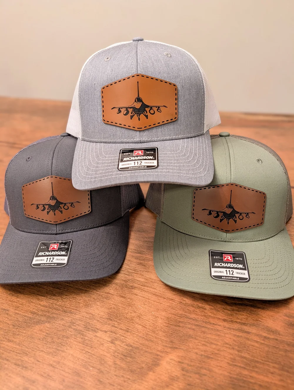 Custom laser-engraved leatherette patch hats on Richardson 112 trucker caps