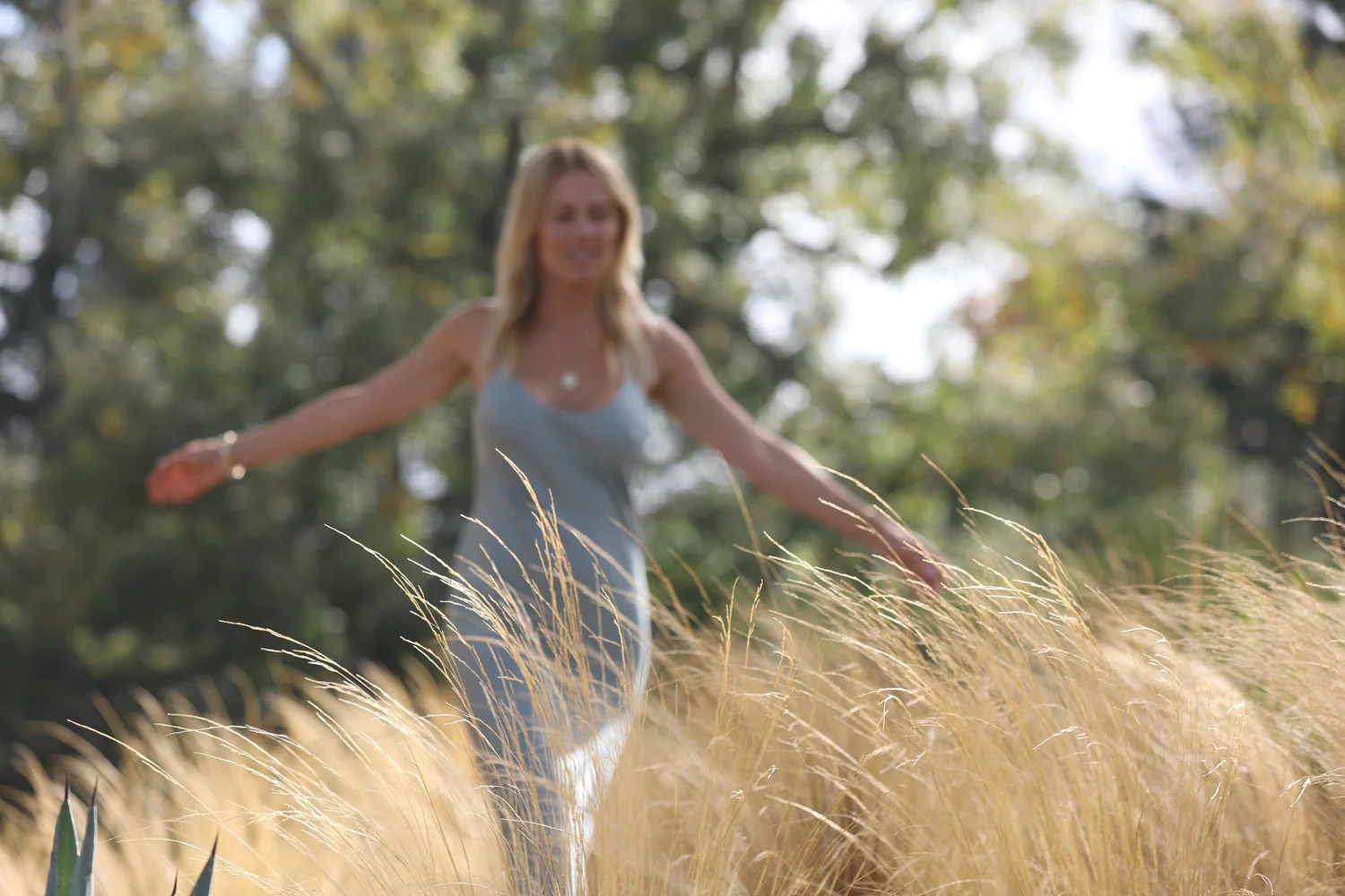 Sondra in a sunlit garden