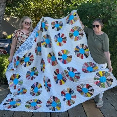 My grandmother worked on this on and off for many years; some of the little patches of material are pretty old, but in good shape. She loved to embroider and crochet afghans, but she always came back to piecing together little quilt pieces. All sewn 