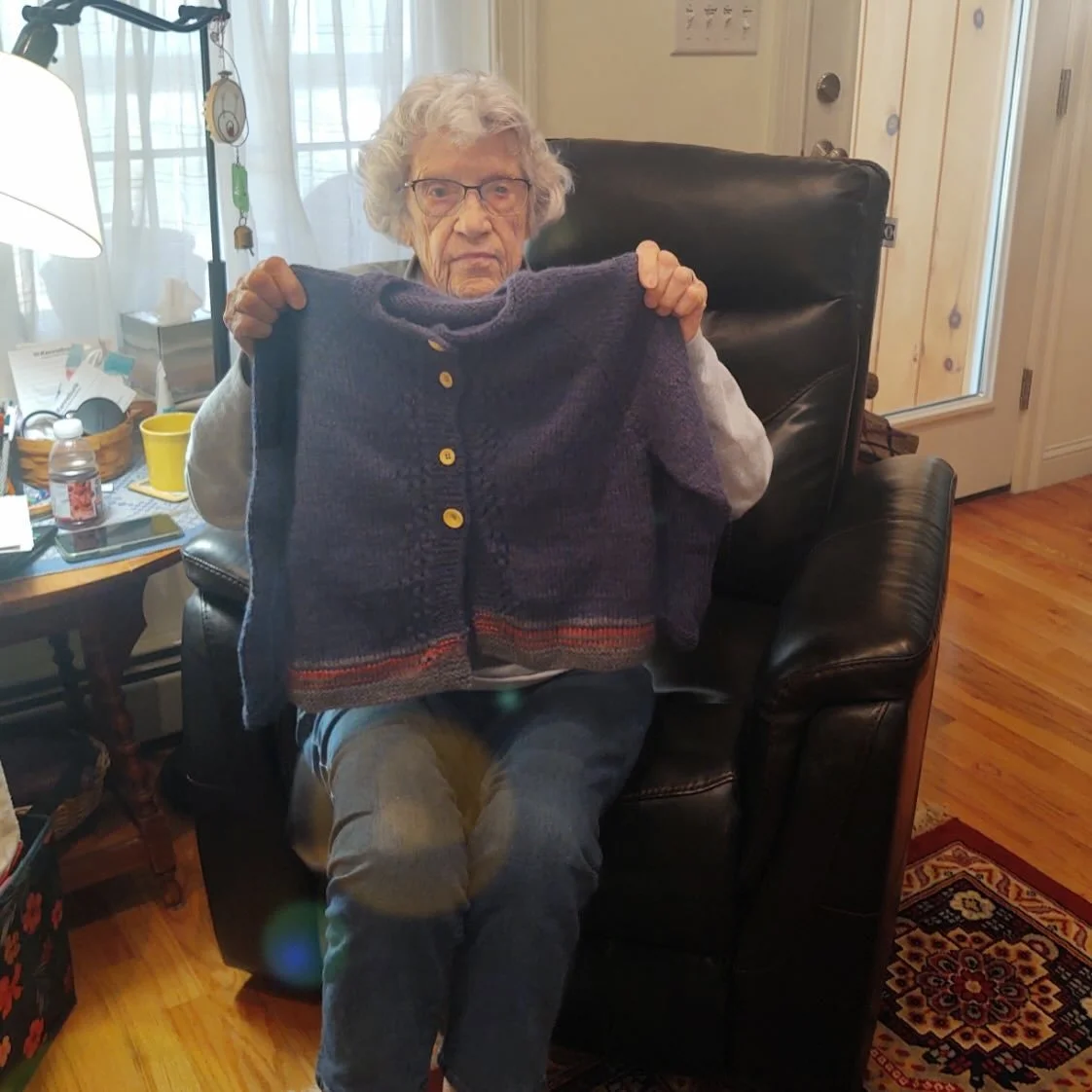 This sweater was begun by Mary (seen in the photo), but an illness left her unable to see. Loose Ends matched her unfinished work with Andrew, a knitter and Loose Ends finisher, who spent about 17 hours completing this for Mary&rsquo;s family.

&ldqu