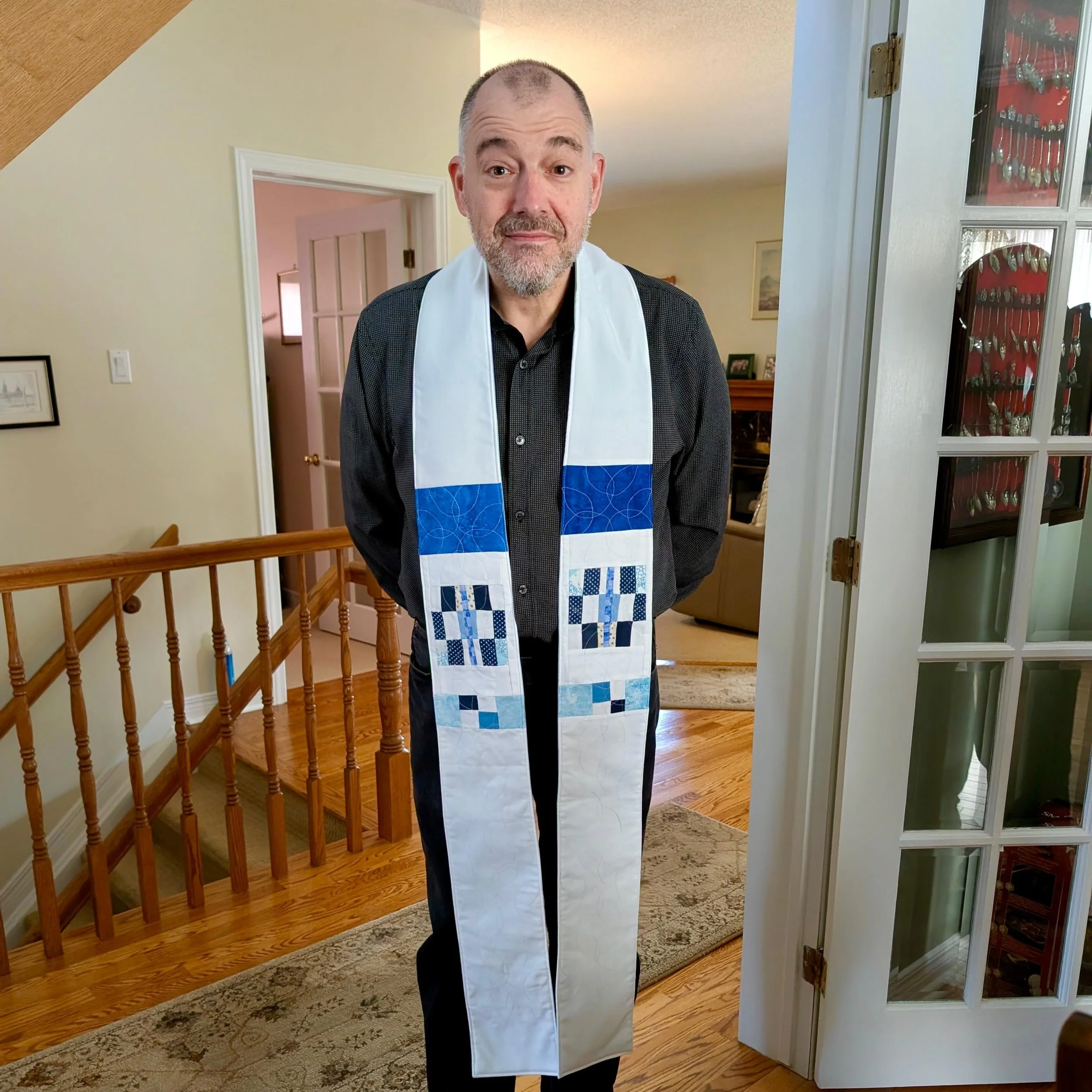 &ldquo;Yolande (my mother-in-law) was quilting a stole for her son, who is an ordained minister. A stole is the sash-like vestment an ordained minister hangs off their shoulder. When her son was ordained, she made several quilted stoles for him, worn
