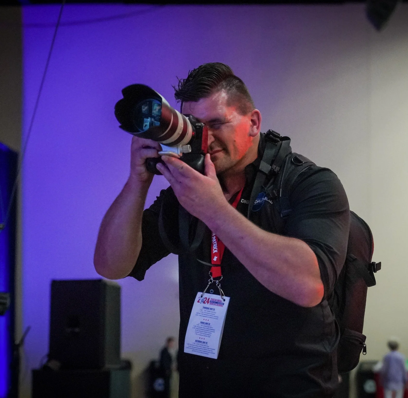 JBW Imagery photographer Jacob photographing an event with a professional camera.
