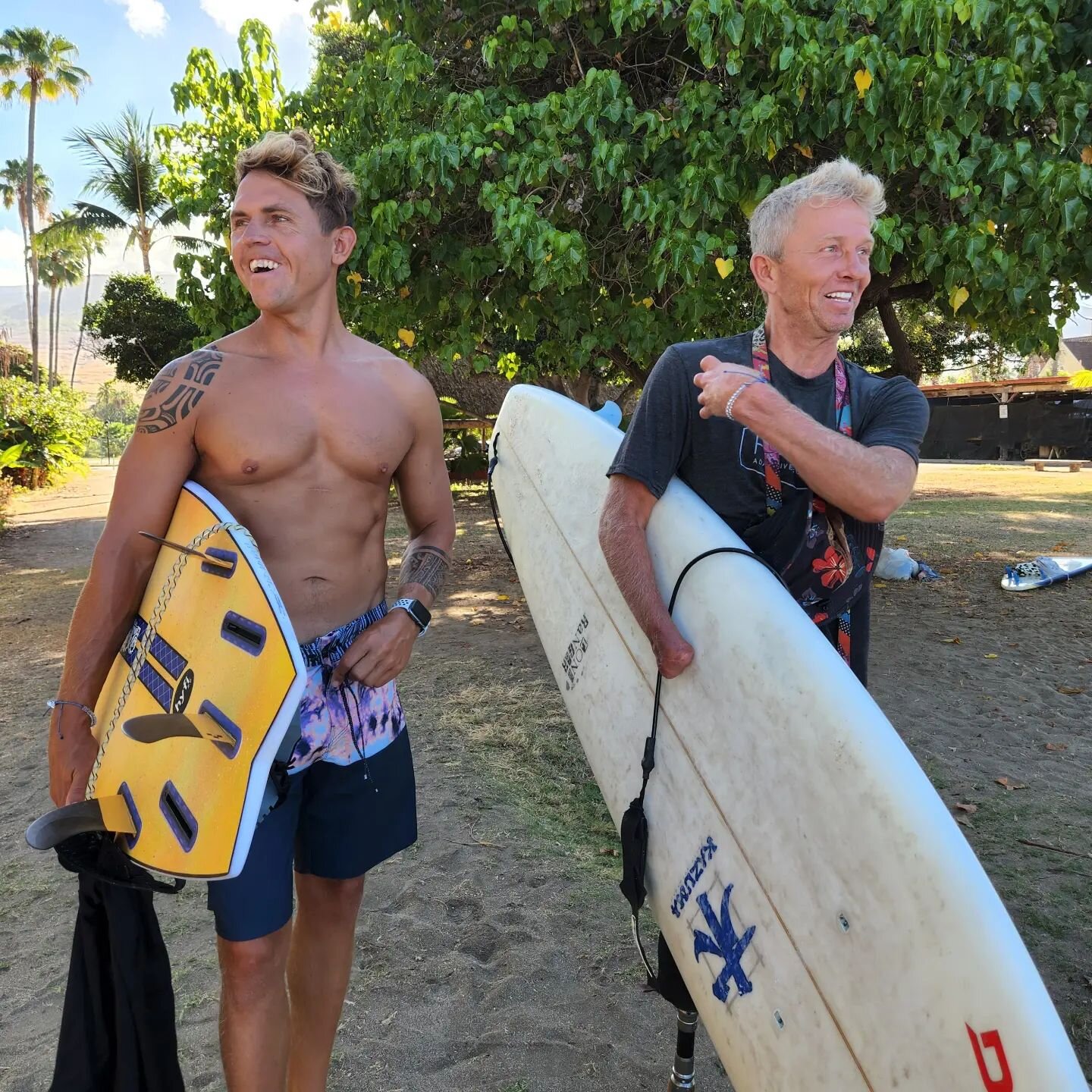Throwback to a Maui training session with @bullyssurfschool last season. We rely heavily on support from the community. Thanks to everyone who helps make us better!
(ID: Josh and Aaron hold surfboards under their arms and smile looking away from the 