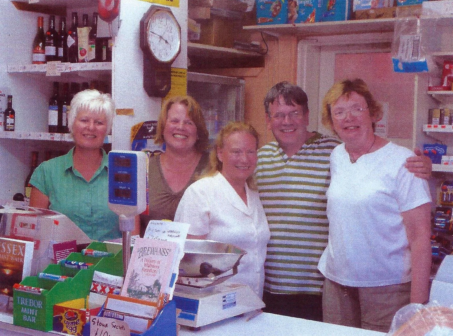 Trevor inside his shop with his wife and customers