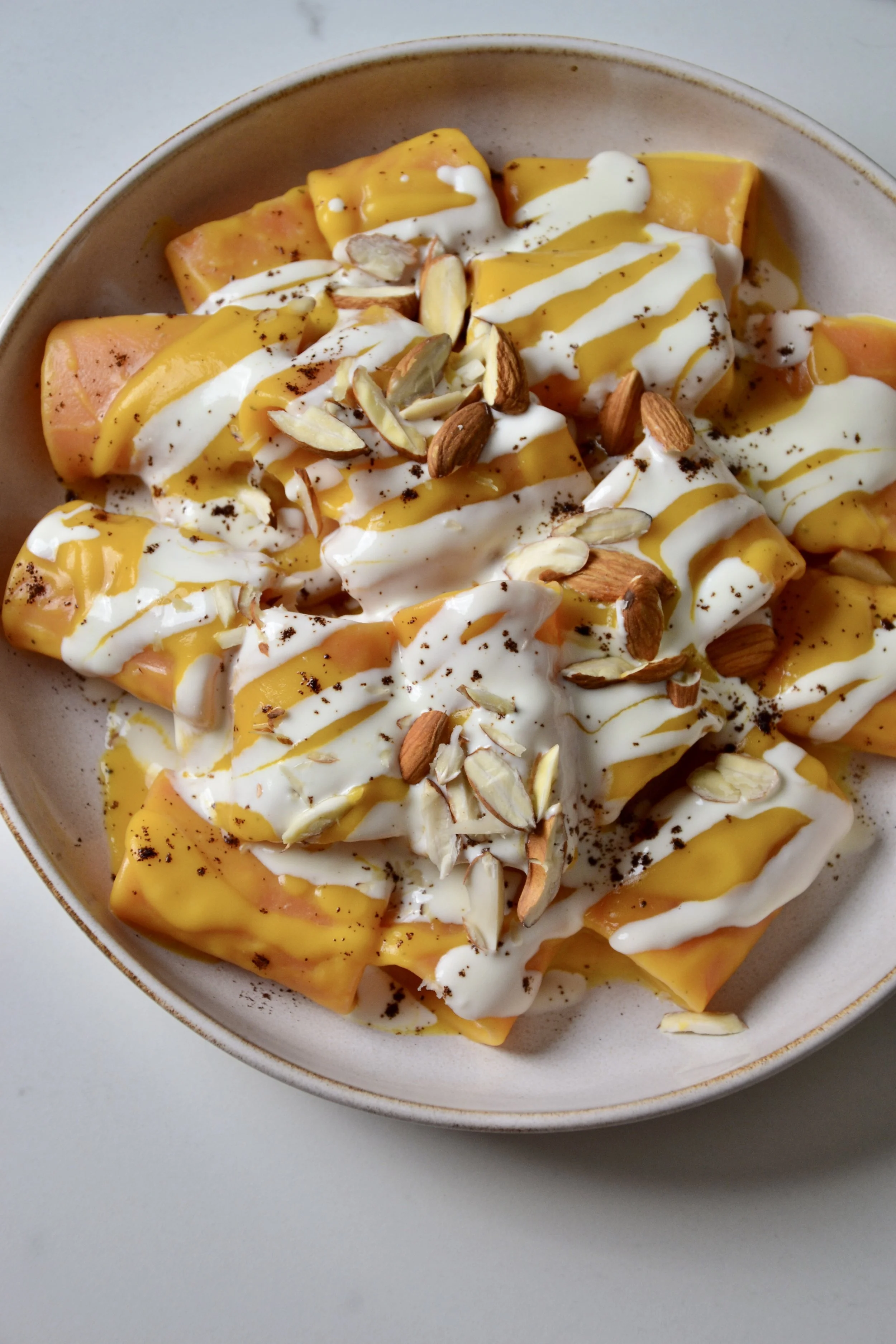 Pumpkin pasta with pecorino sauce, coffee & almonds