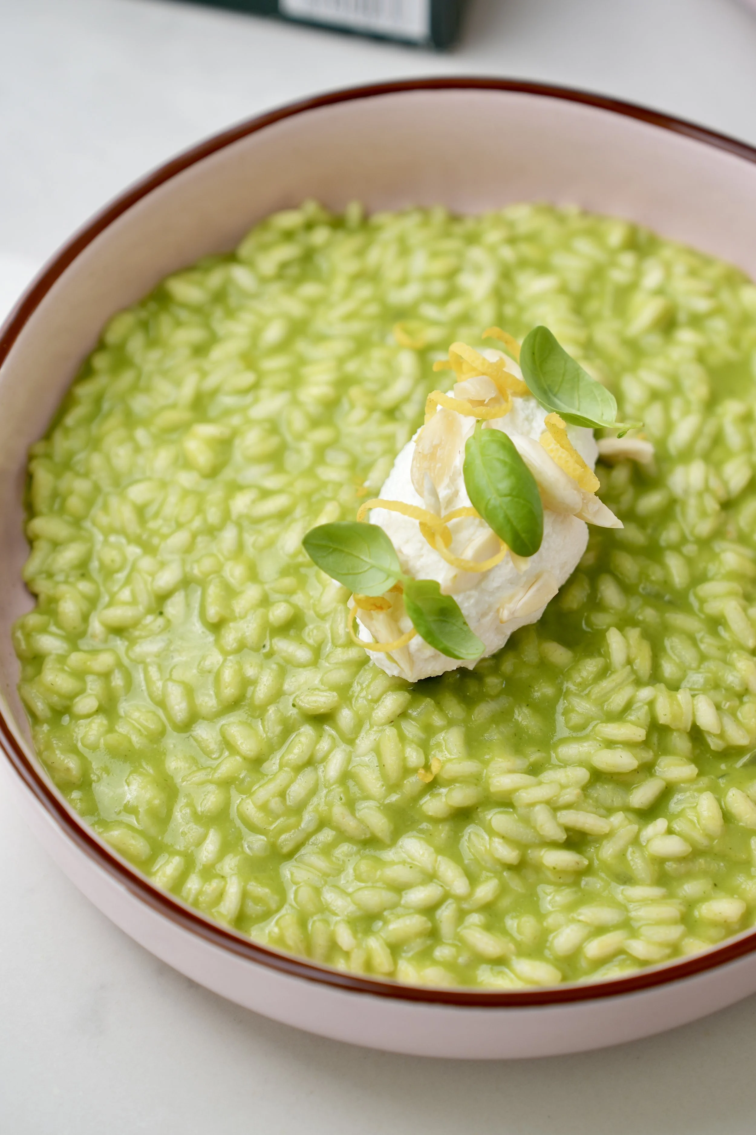 Basil risotto with smoked ricotta, sea bream, lemon and almonds