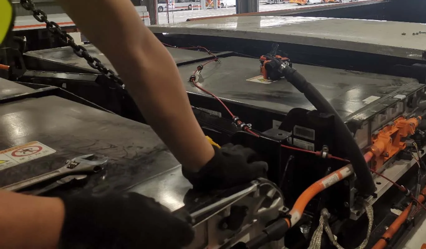 Our EV battery specialist is working on the electrical components of an electric vehicle in our customer's site.