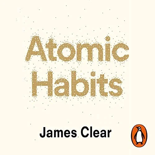 Book cover titled 'Atomic Habits' by James Clear, featuring a minimalist design with small gold particles and the Penguin logo at the bottom right.
