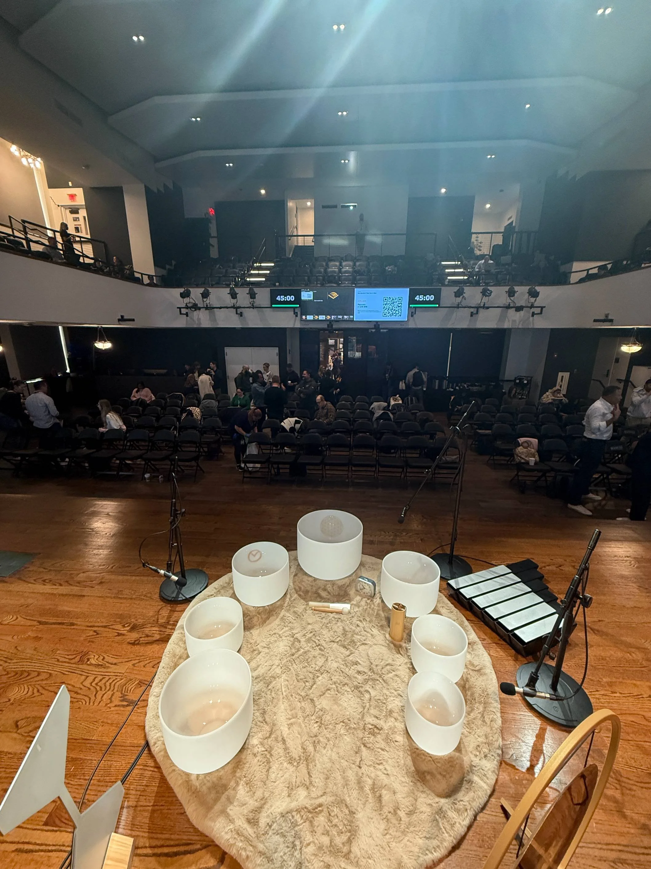 Corporate sound bath session with crystal singing bowls at Audible NYC, designed for team wellness, relaxation, and stress relief.