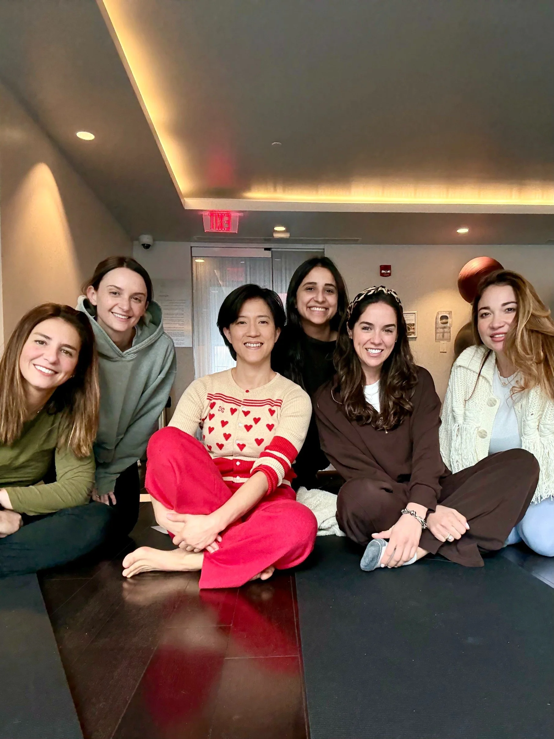 Six friends smiling together after a private group sound bath at Soundawn's Brooklyn studio — a shared gift-card experience for birthdays and celebrations in NYC.