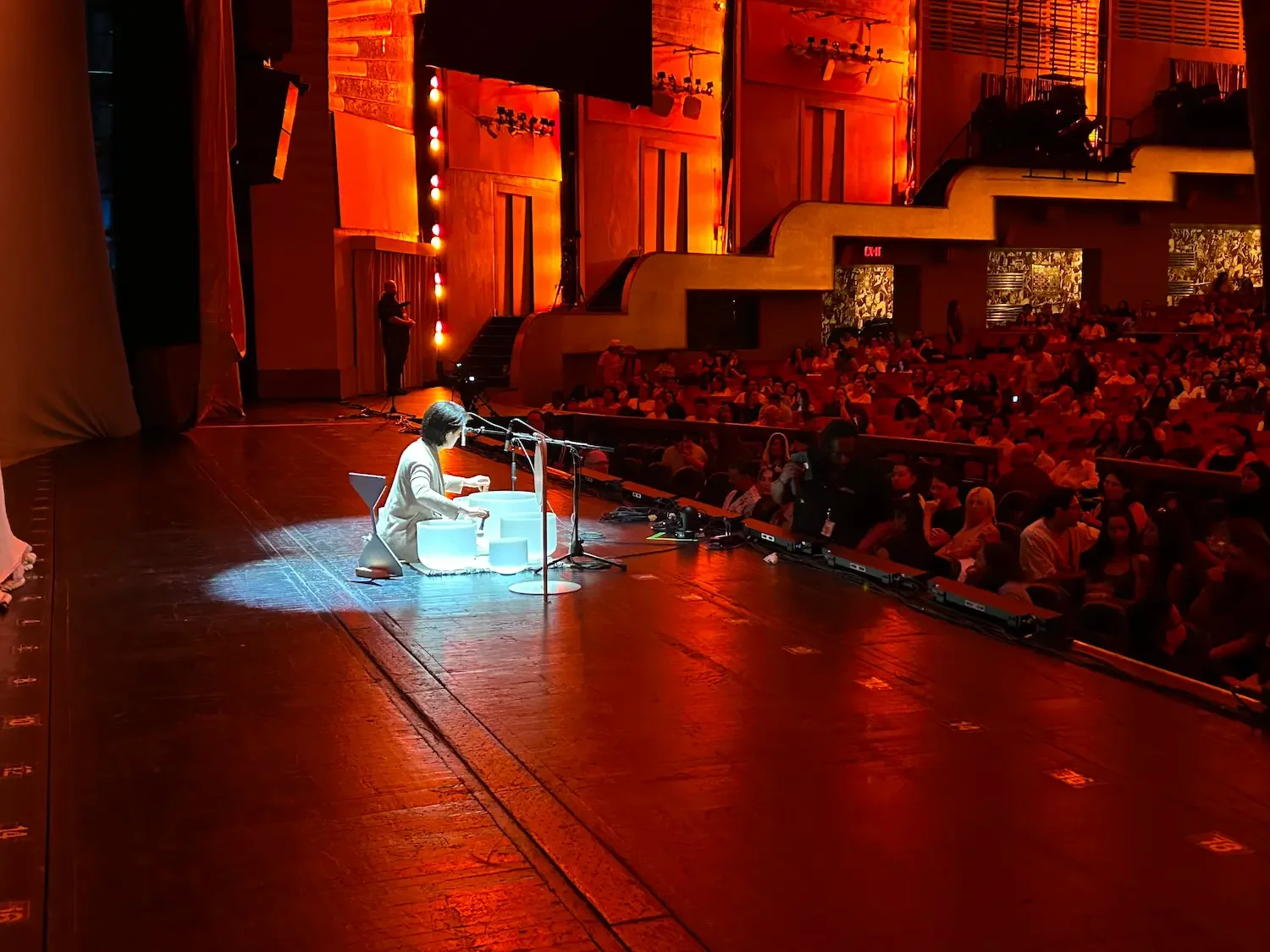 Natalie Chan performing crystal sound bowls on stage at Radio City Music Hall, opening for CA7RIEL & Paco Amoroso — Soundawn.