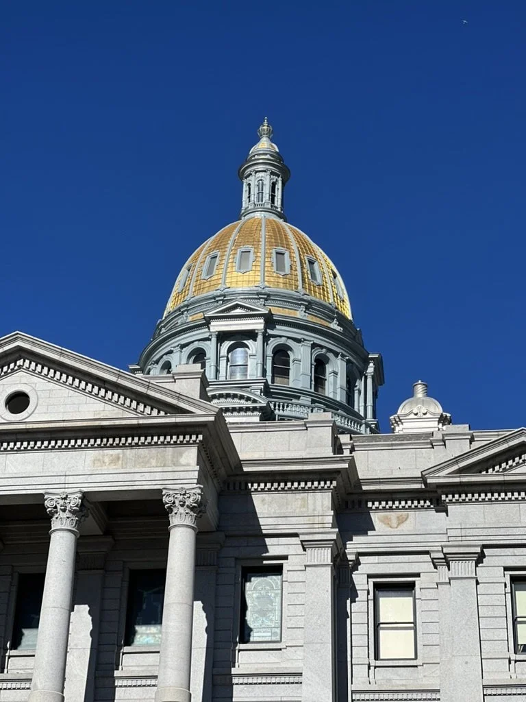 Colorado State Capital with a plane in the background.