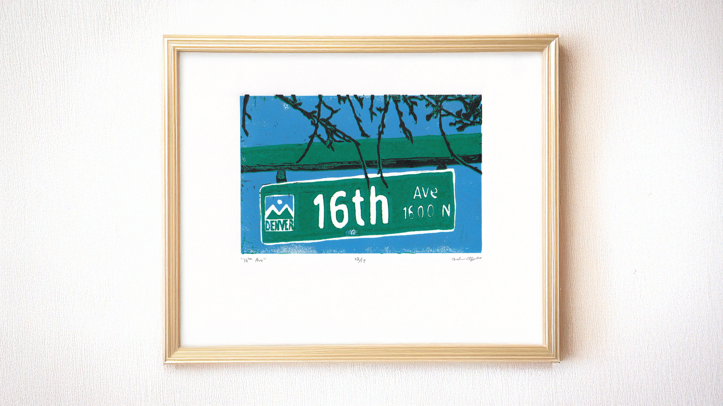 A framed version of a linocut print of a street sign in Denver, Colorado, that says "16th Ave". It is a three-color reduction print in green, blue, and black.