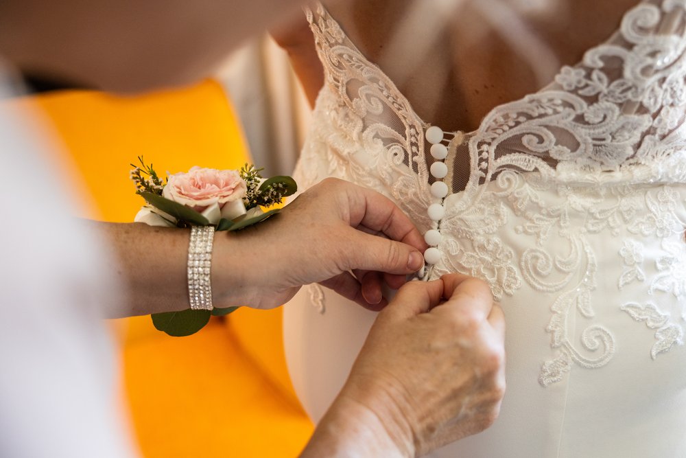 Alex Maldonado Photography | Chicago Wedding Photographer | bride getting to dress detail shot with mom helping.jpg