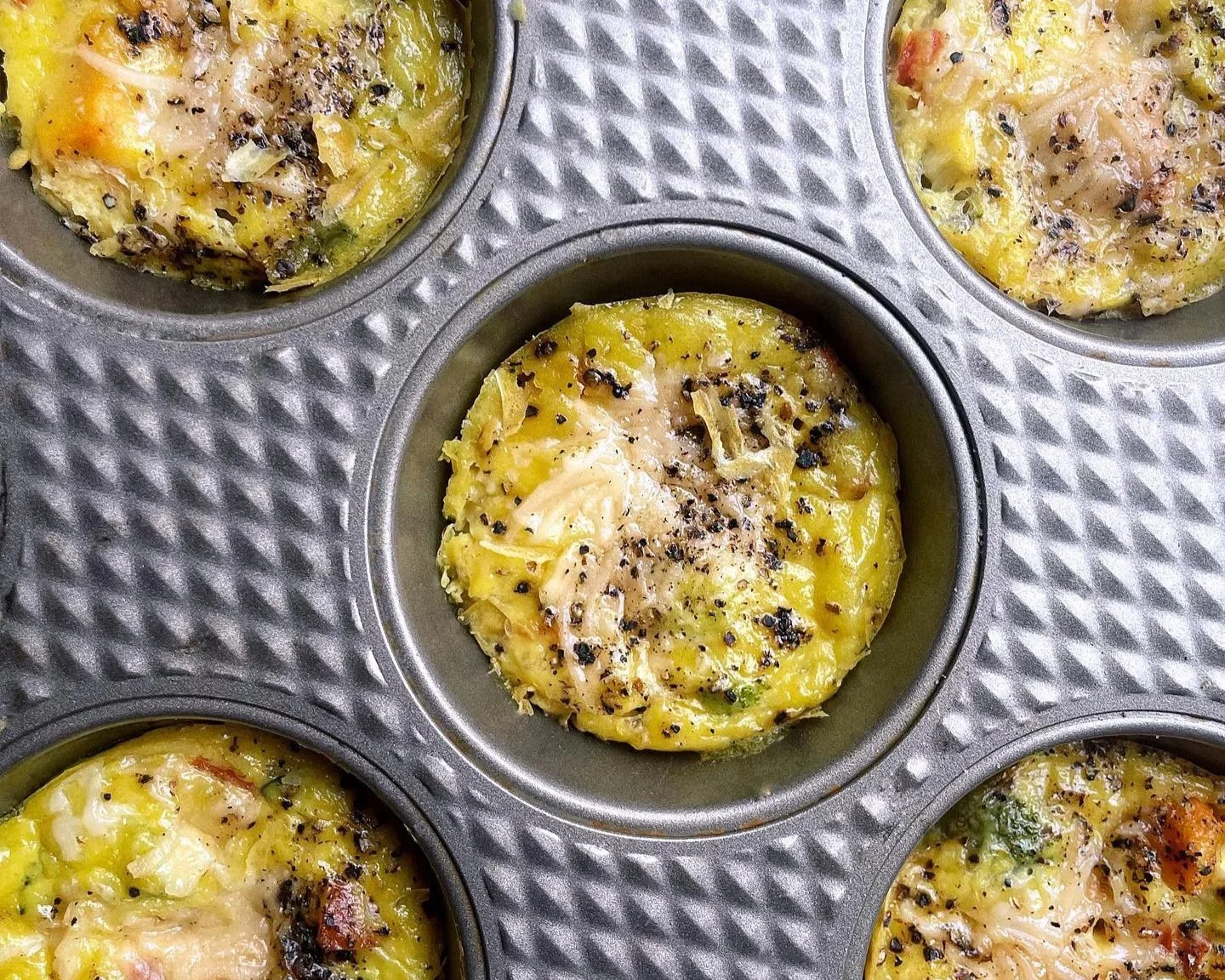 veggie egg bites with just egg, broccoli, sweet potatoes, bell pepper, and dairy-free parmesan - meatless and wheatless recipe