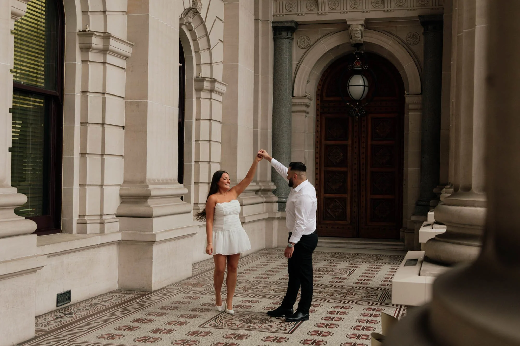 Couple dancing in front of parliament during Engagement photography session, Melbourne city wedding 