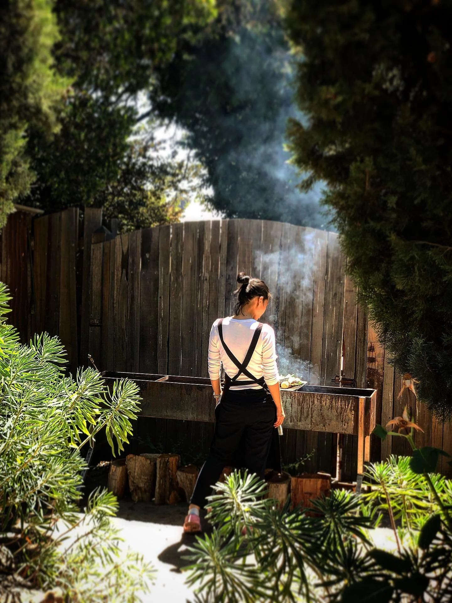 Nicole on the Parrilla charring vegetables for Escalivada.