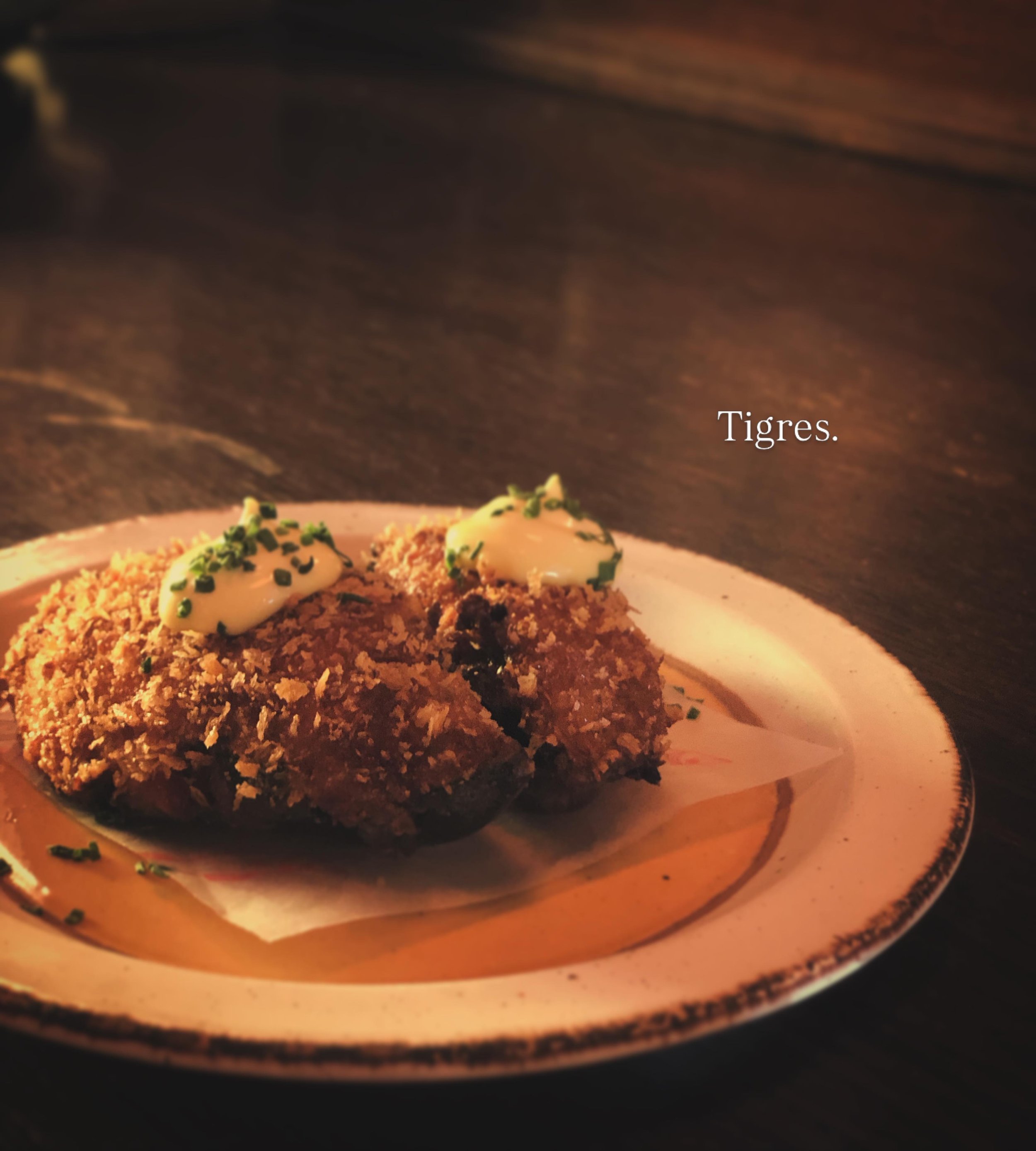 A cute snap of a pair of Tigres.

This has become a little off-menu favourite here. Meaning &lsquo;Tigers&rsquo; the tapa is essentially a mussel croqueta, served in a mussel shell. 
Poached Portarlington black mussels are poached, chopped and folded