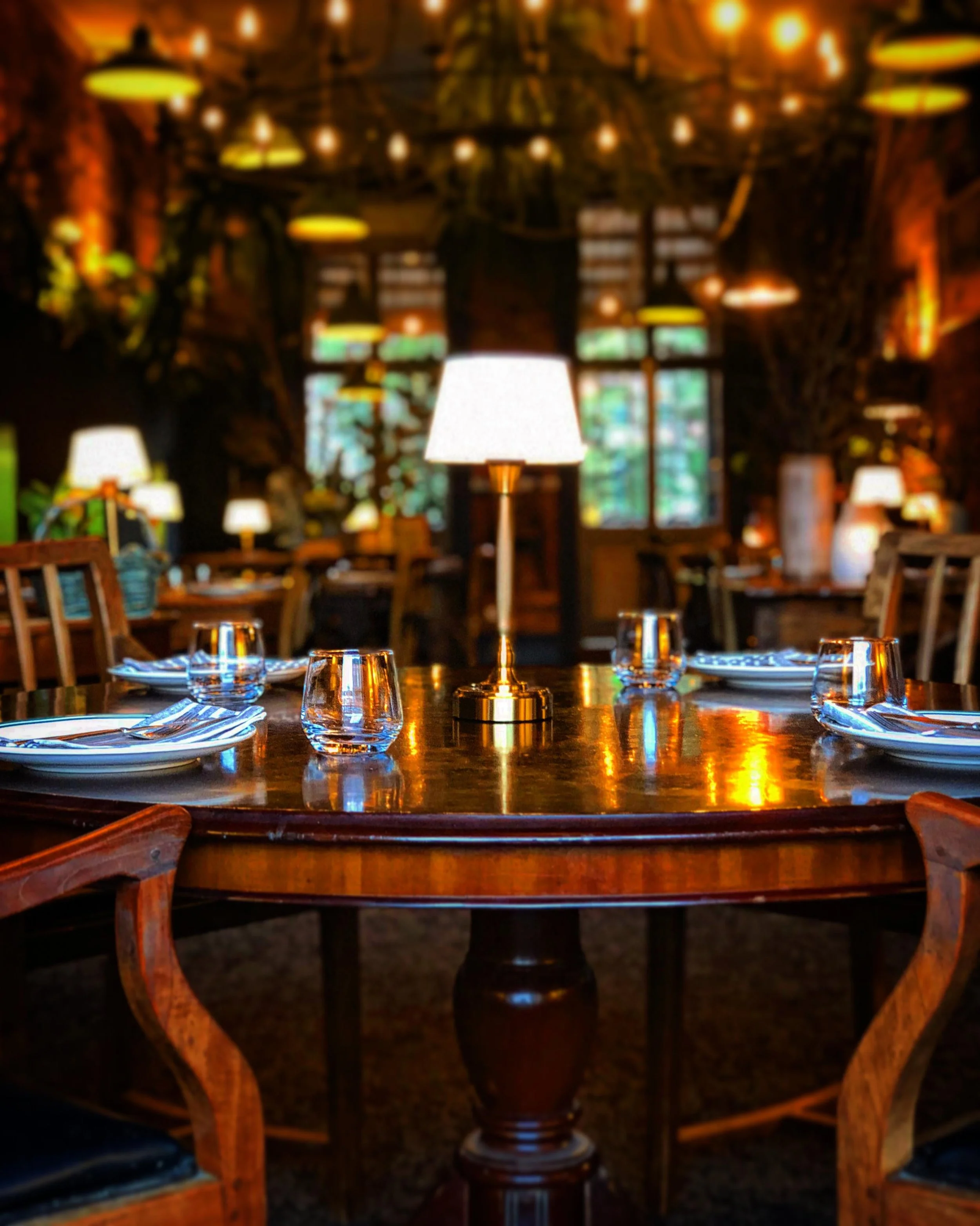 Our main dining room.

Specifically Table 1, which has a lovely large round table at the top of the room, by the window, with green leather Chesterfields to lounge on during your time with us.. a special spot. Yes you can request it.