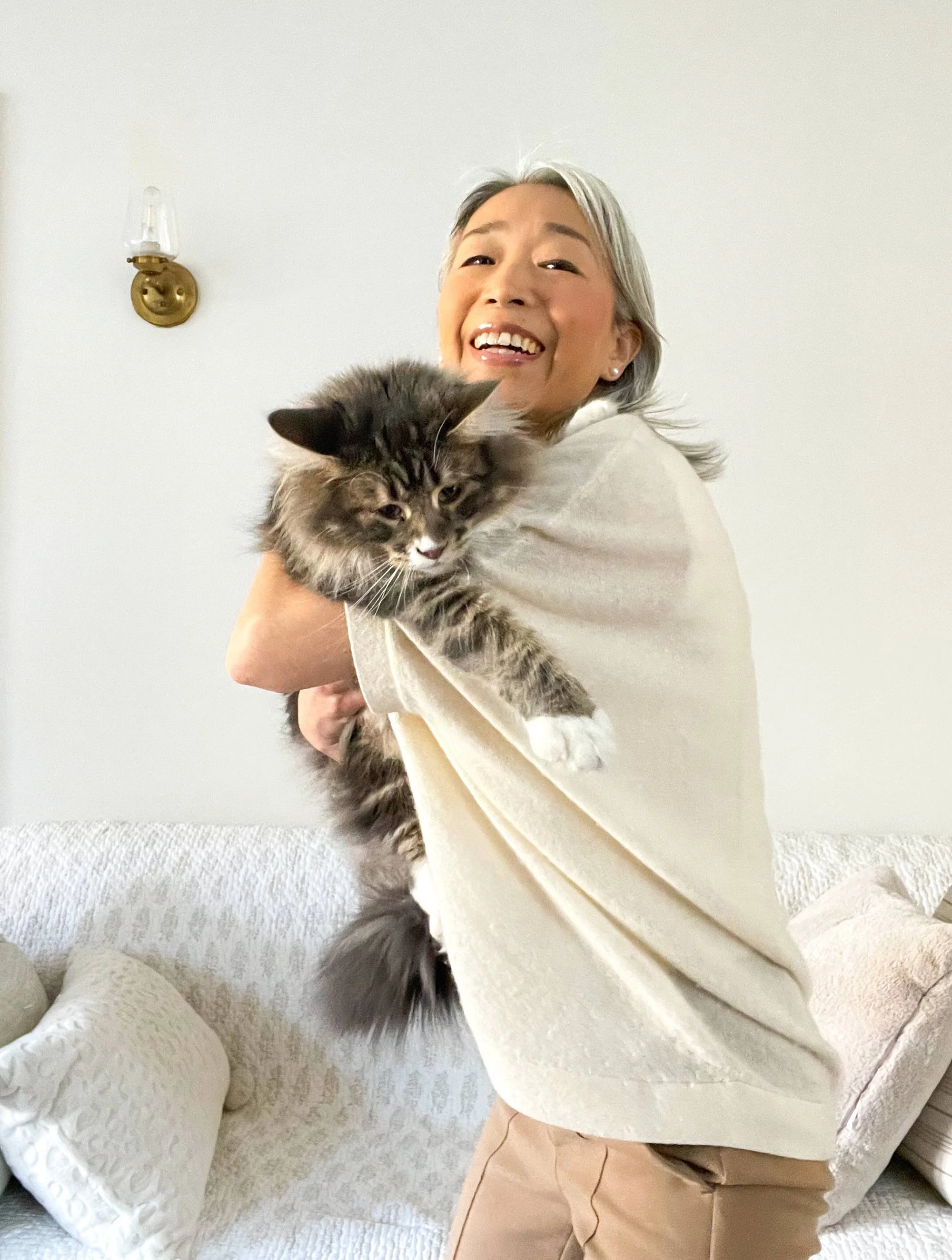 Natsumi enjoying a quiet moment with her cat, reflecting her authentic lifestyle and creative work.i