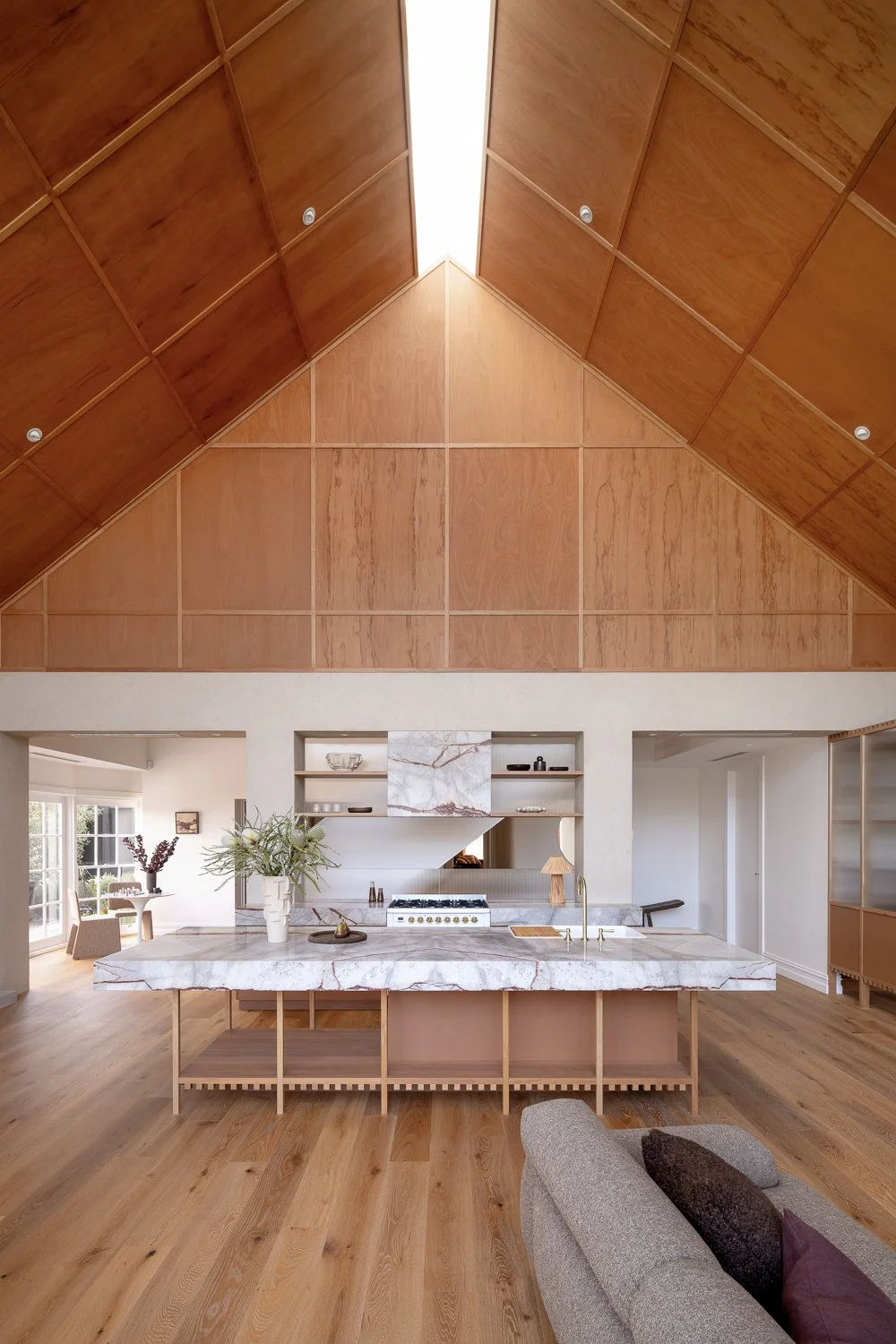 Brighton House — At ground level, a clay-rendered colonnade forms a threshold between house and garden, framing everyday spaces and concealing services.