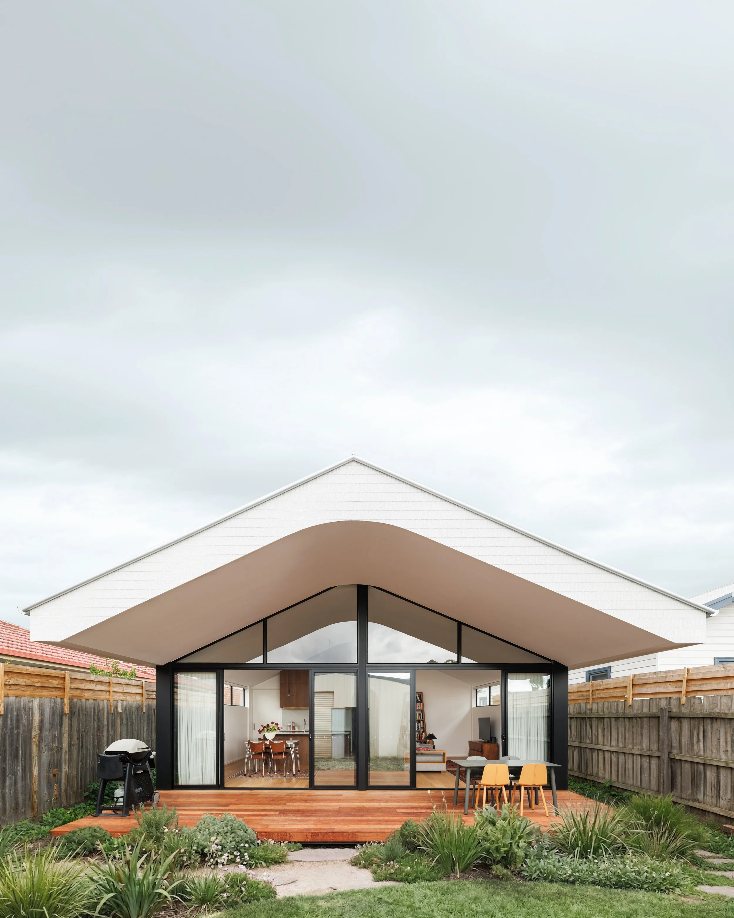 Coburg house- a gentle curve in the ceiling along with highlight windows is introduced to make the roof float and the living space feel open and breezy.