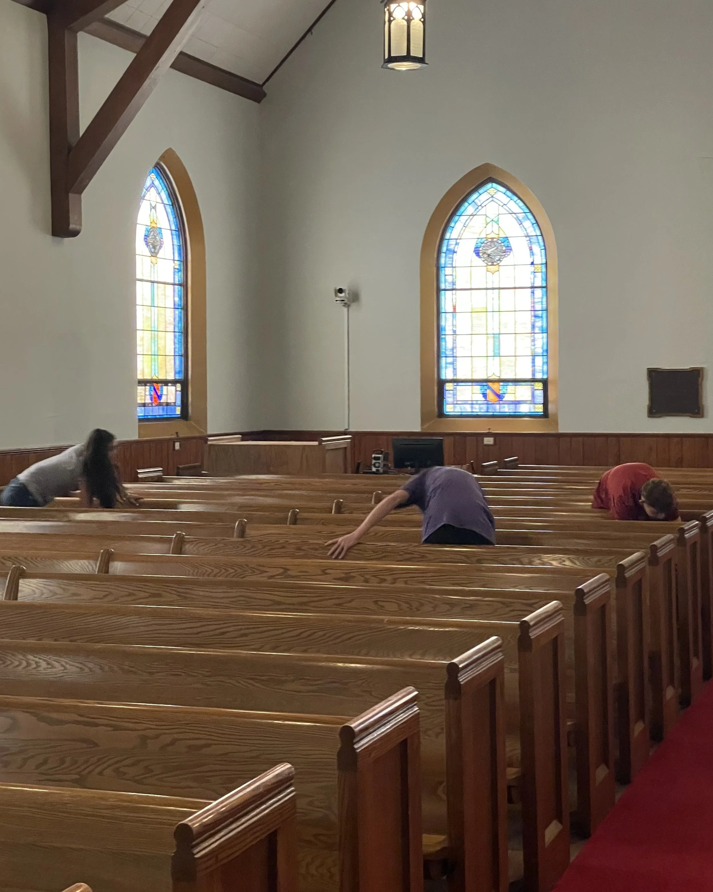 Polishing pews for Triune Mercy Center's chapel