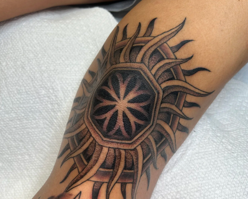 Geometric mandala knee tattoo.  Dotwork shading 
