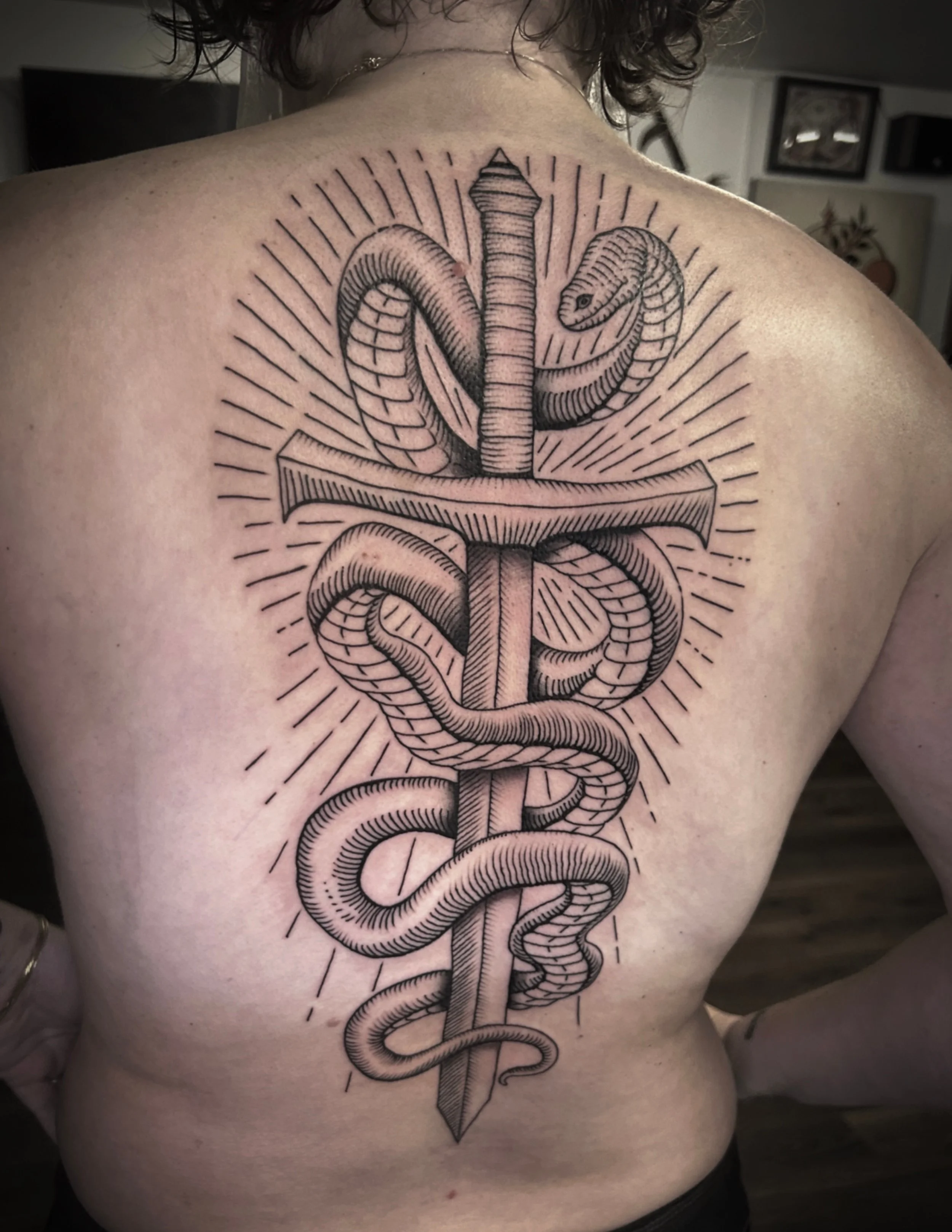Woodcut snake and sword tattoo