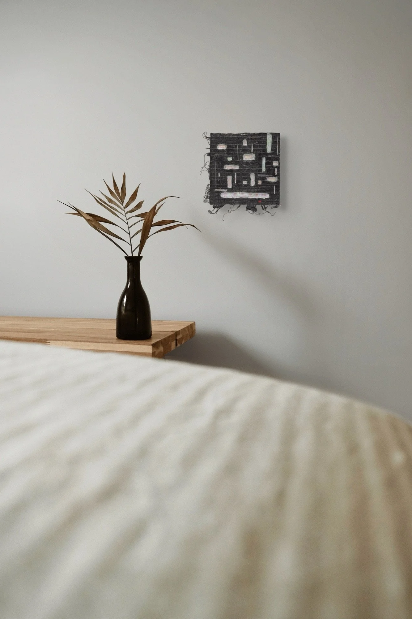 Black #3, layered and hand-carved paper artwork by Michele Bonds, shown in contemporary interior
