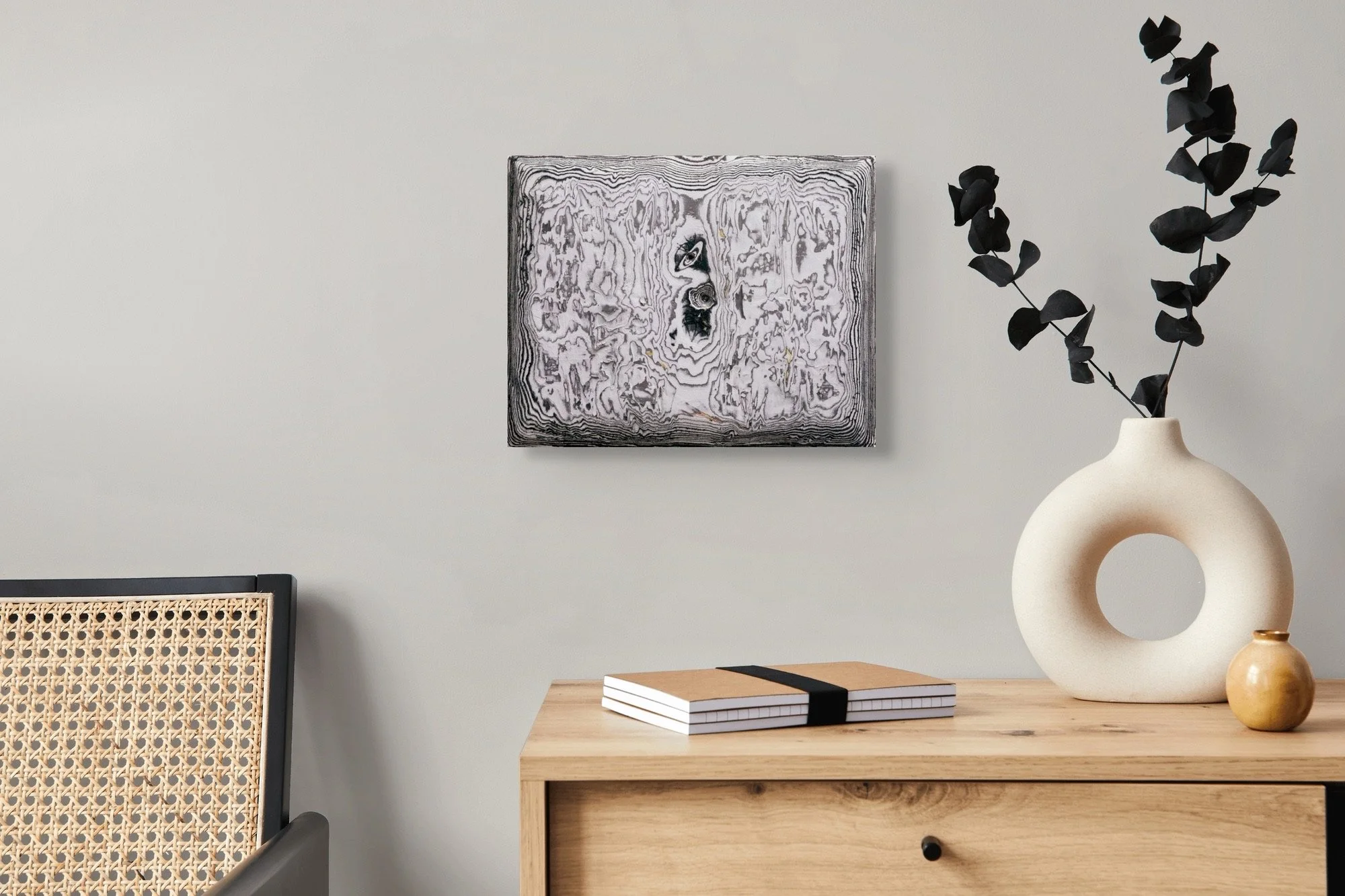Ringed Aperture, layered and hand-carved paper artwork by Michele Bonds, shown in contemporary interior