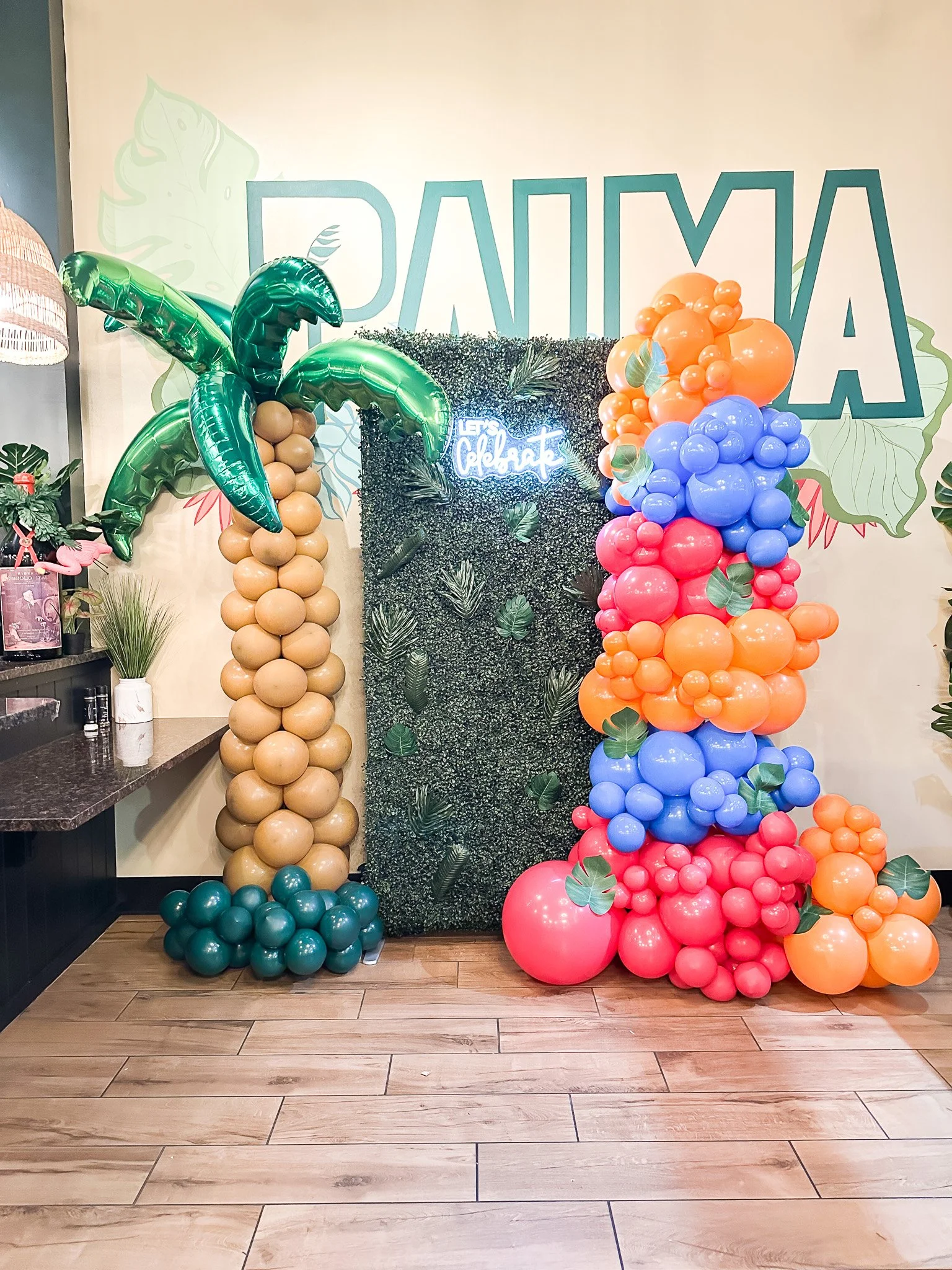 Grass wall with organic balloon garland  corporate one year anniversary