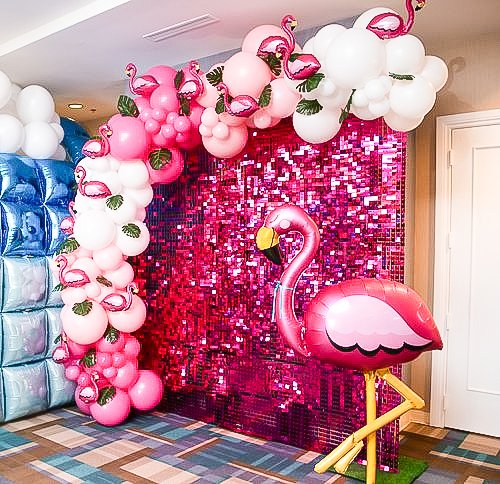 Pink shimmer wall with organic balloon garland
