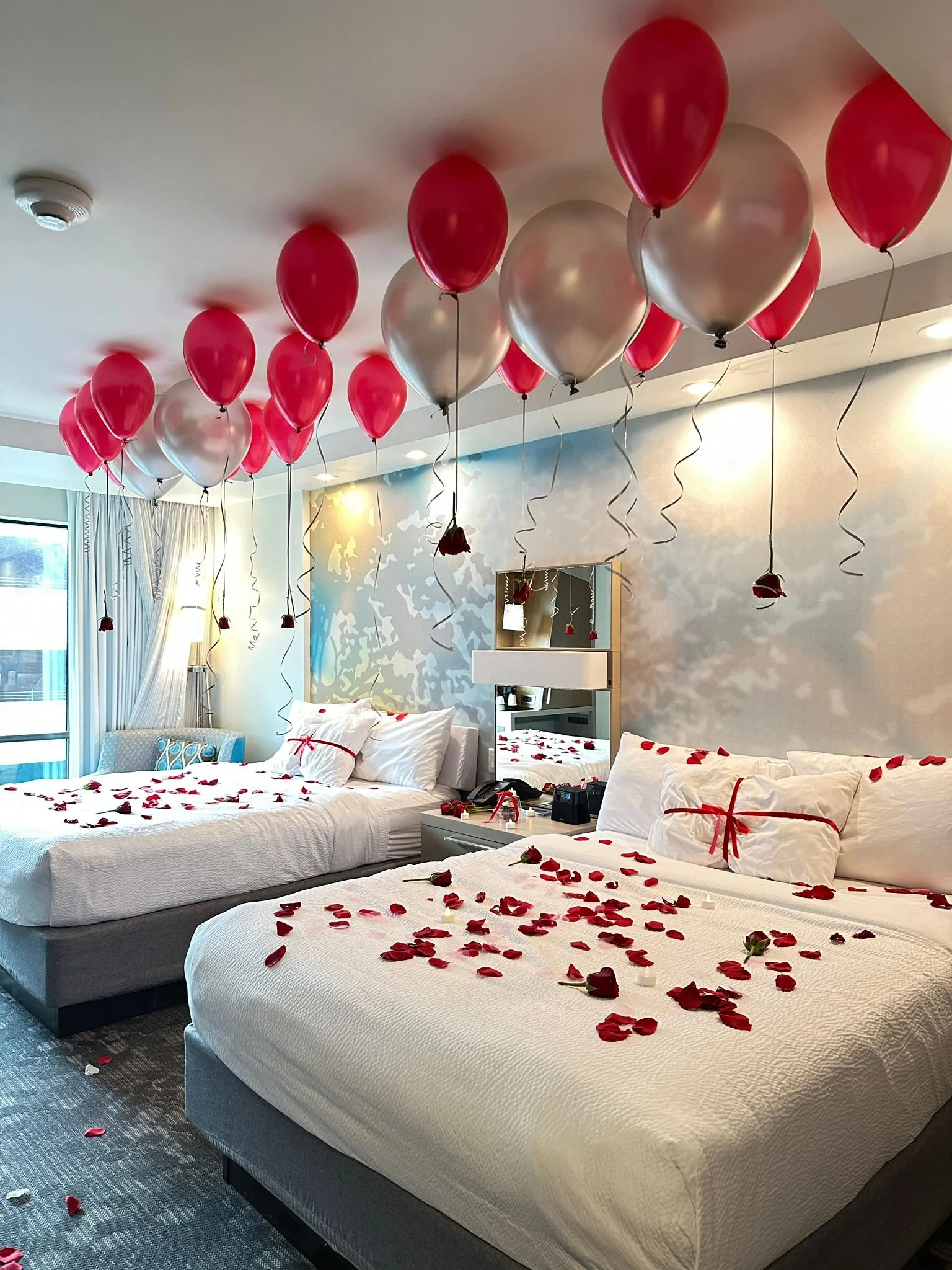 Valentine's Day hotel room decor balloons and roses.