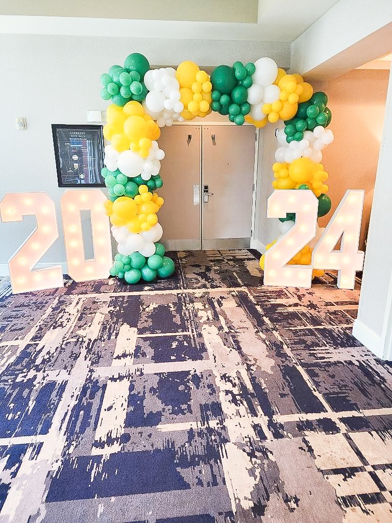 Graduation balloon arch with light-up marquee numbers.