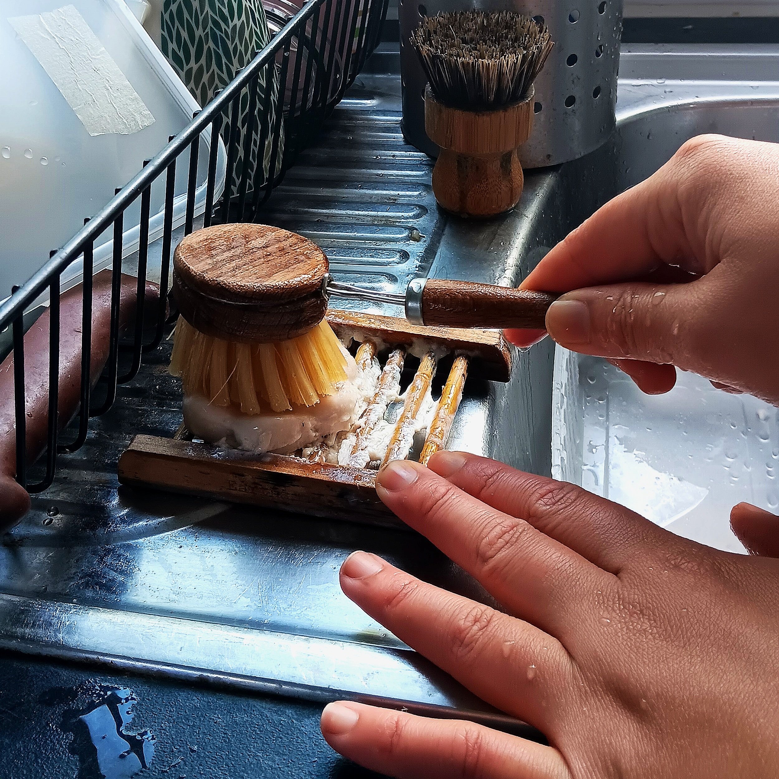 Wet your dish brush and rub the brush against dish soap to pick up some products.