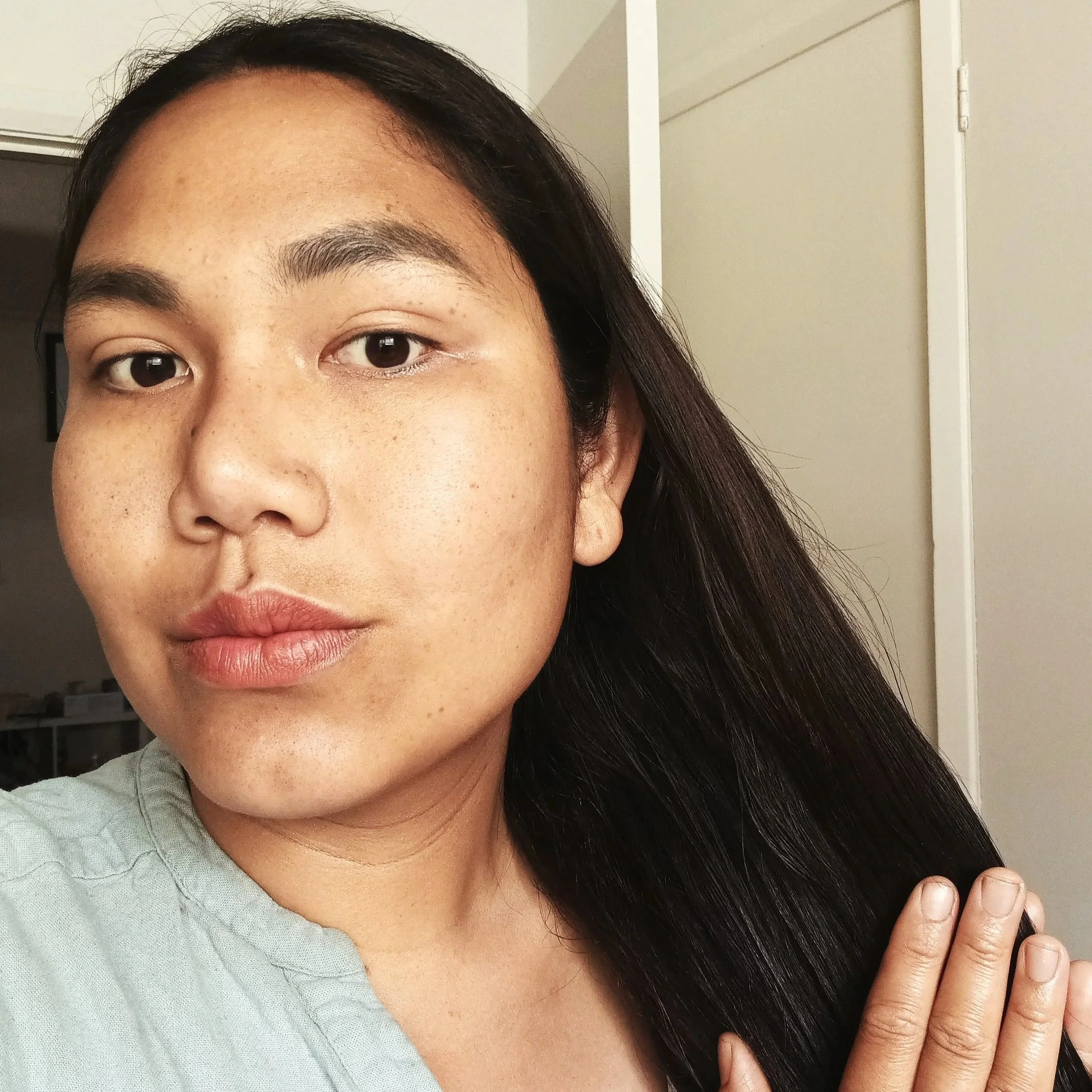 gently massage the oil into your hair strands, working from the mid-lengths down to the tips.