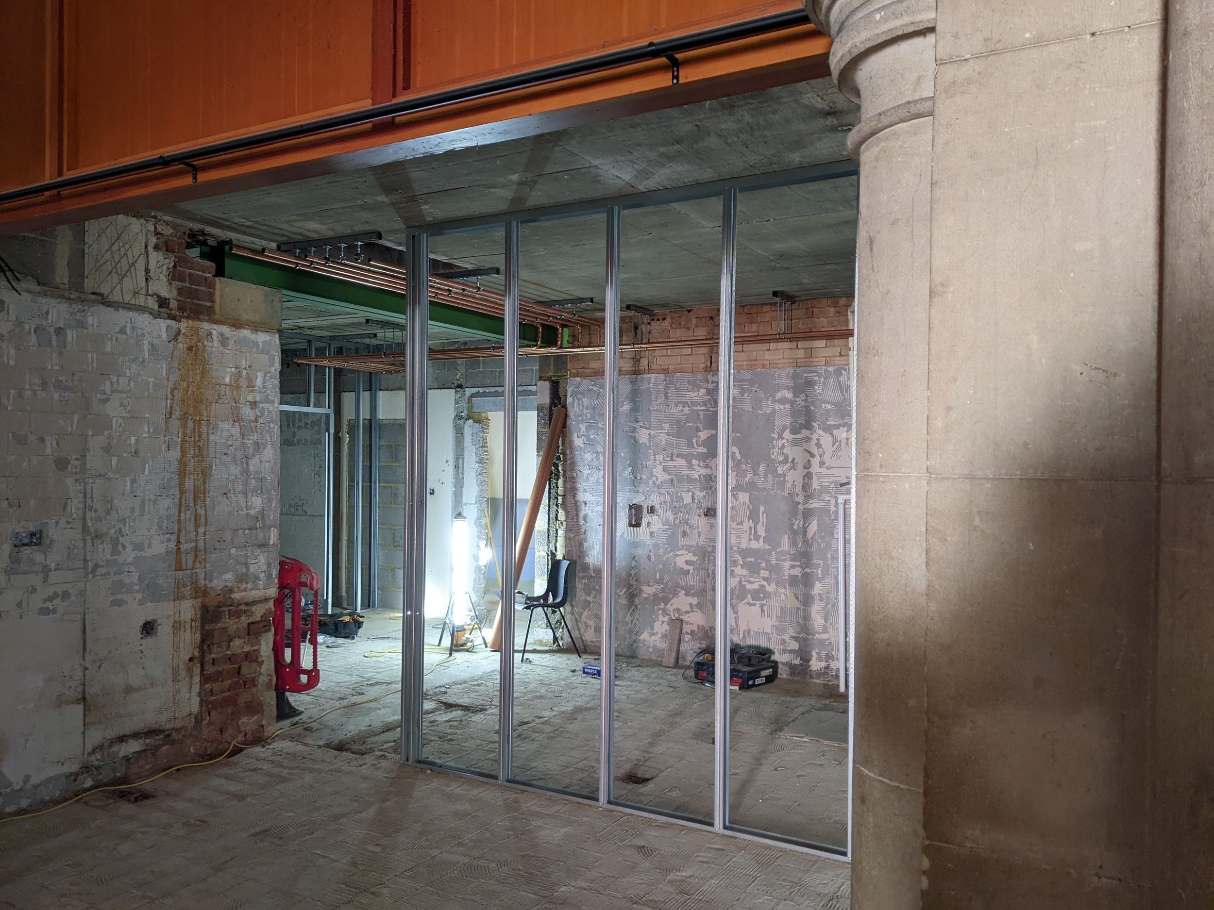 New partition wall framework behind the café serving counter