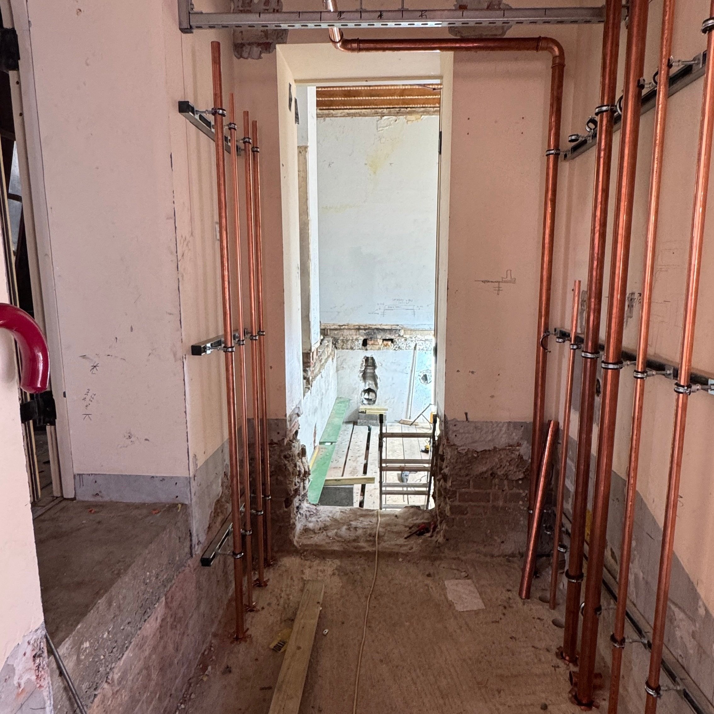 Old steps to the finance office (vestry) removed; pipework for the new boilers