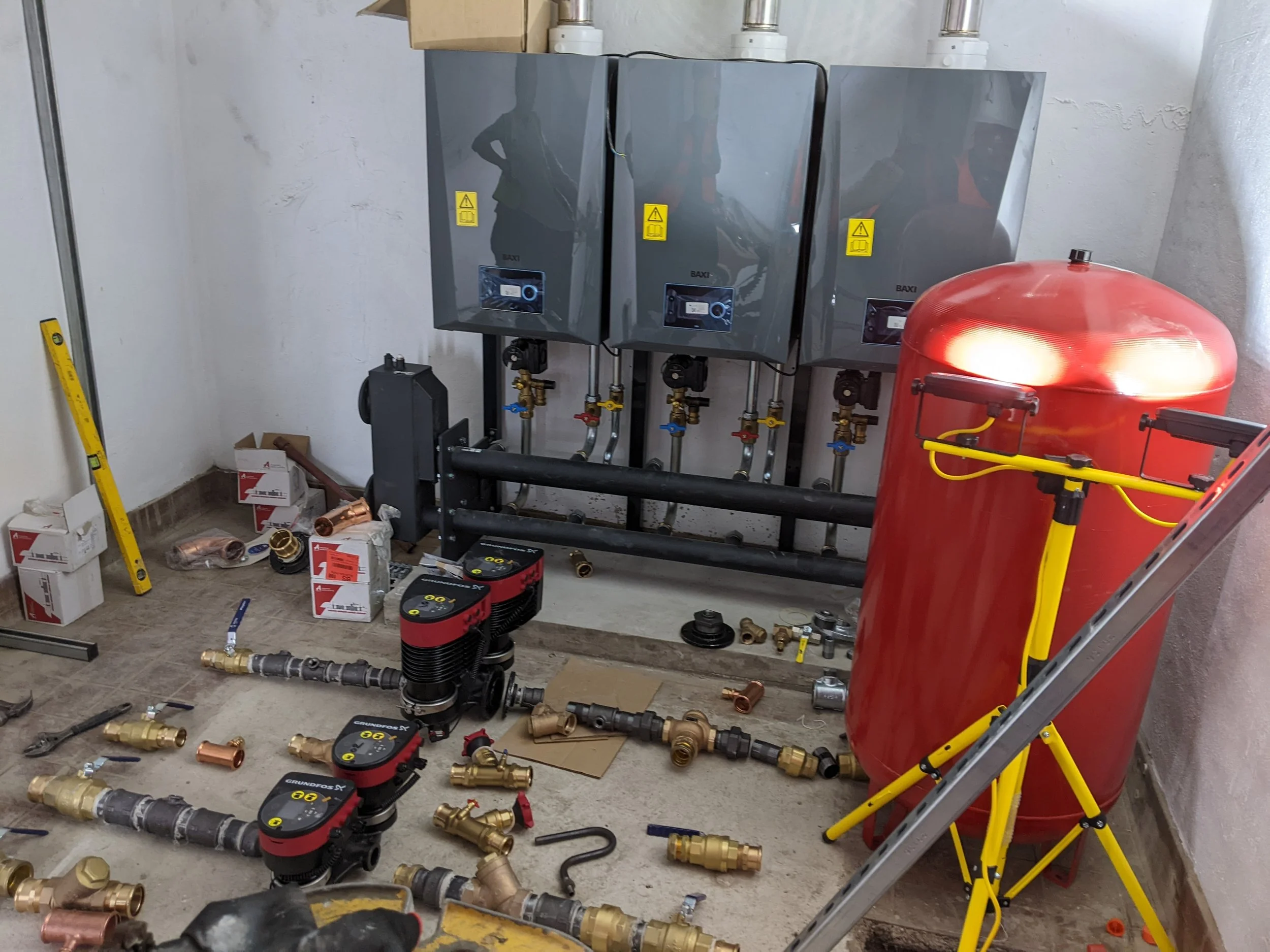 Three new boilers and an expansion tank in the basement plant room