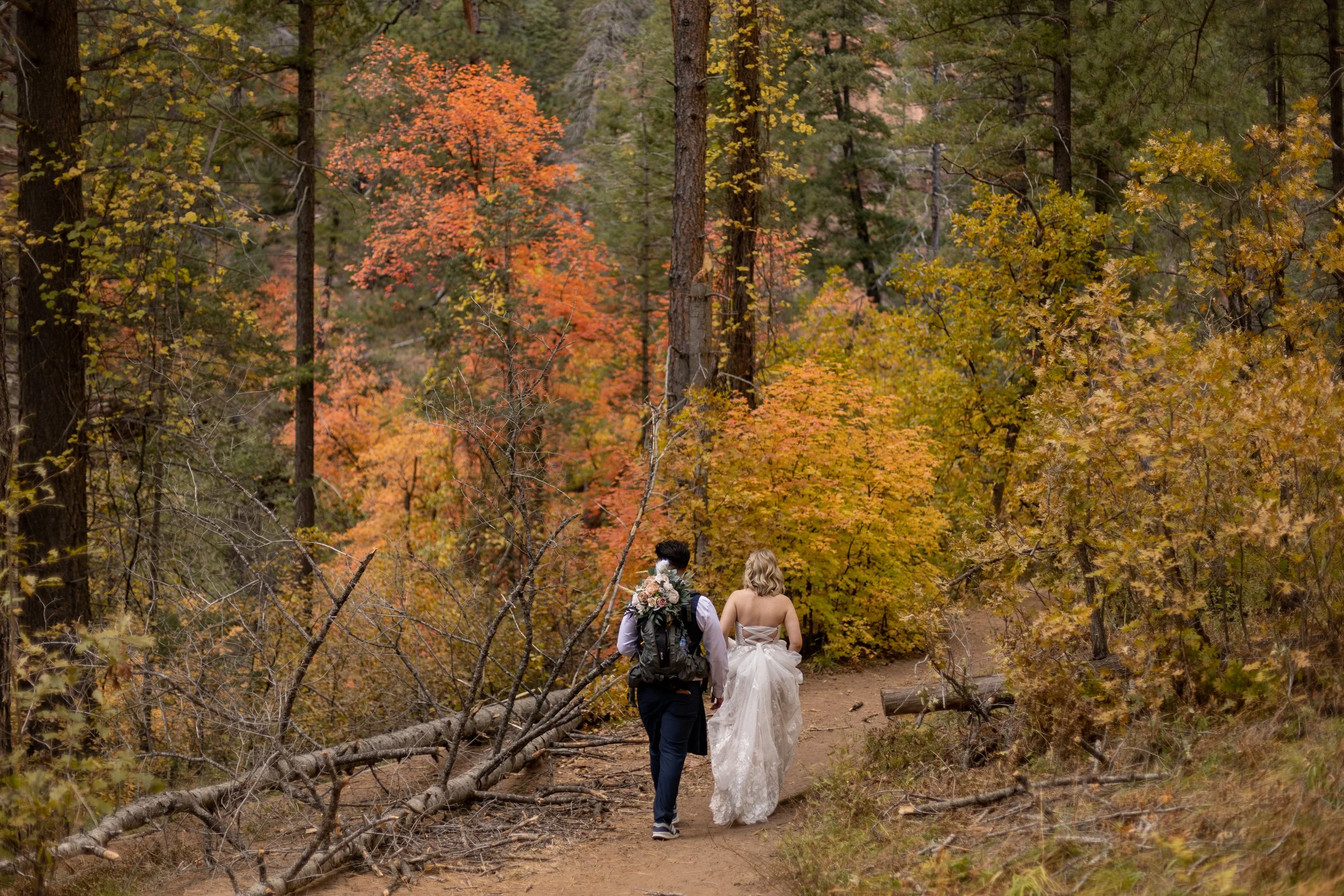 wedding couple walking in west fork trail by Sedona elopement photographer Nick Patton