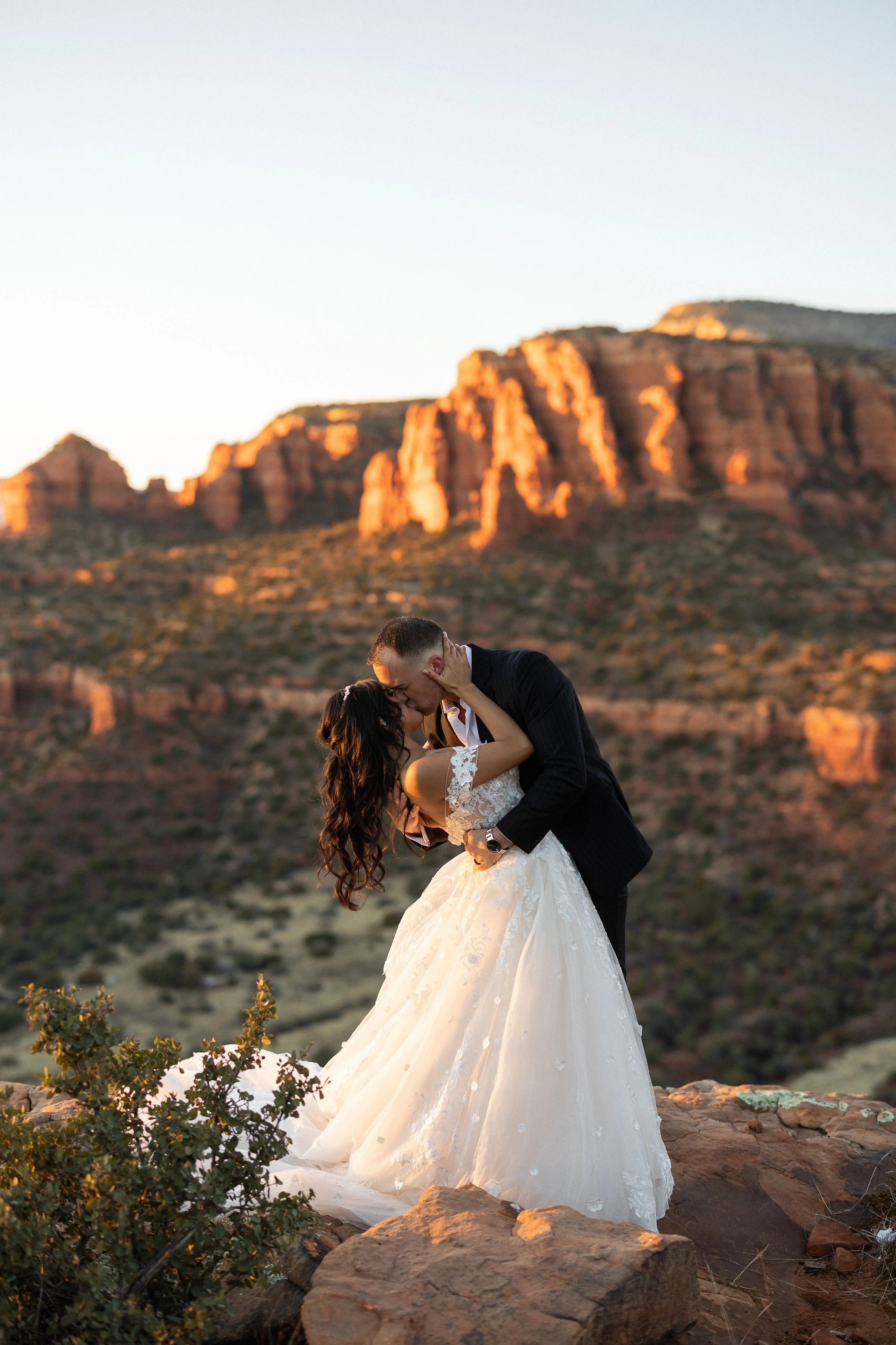 wedding couple kissing at Sedona sunset by Sedona elopement photographer Nick Patton