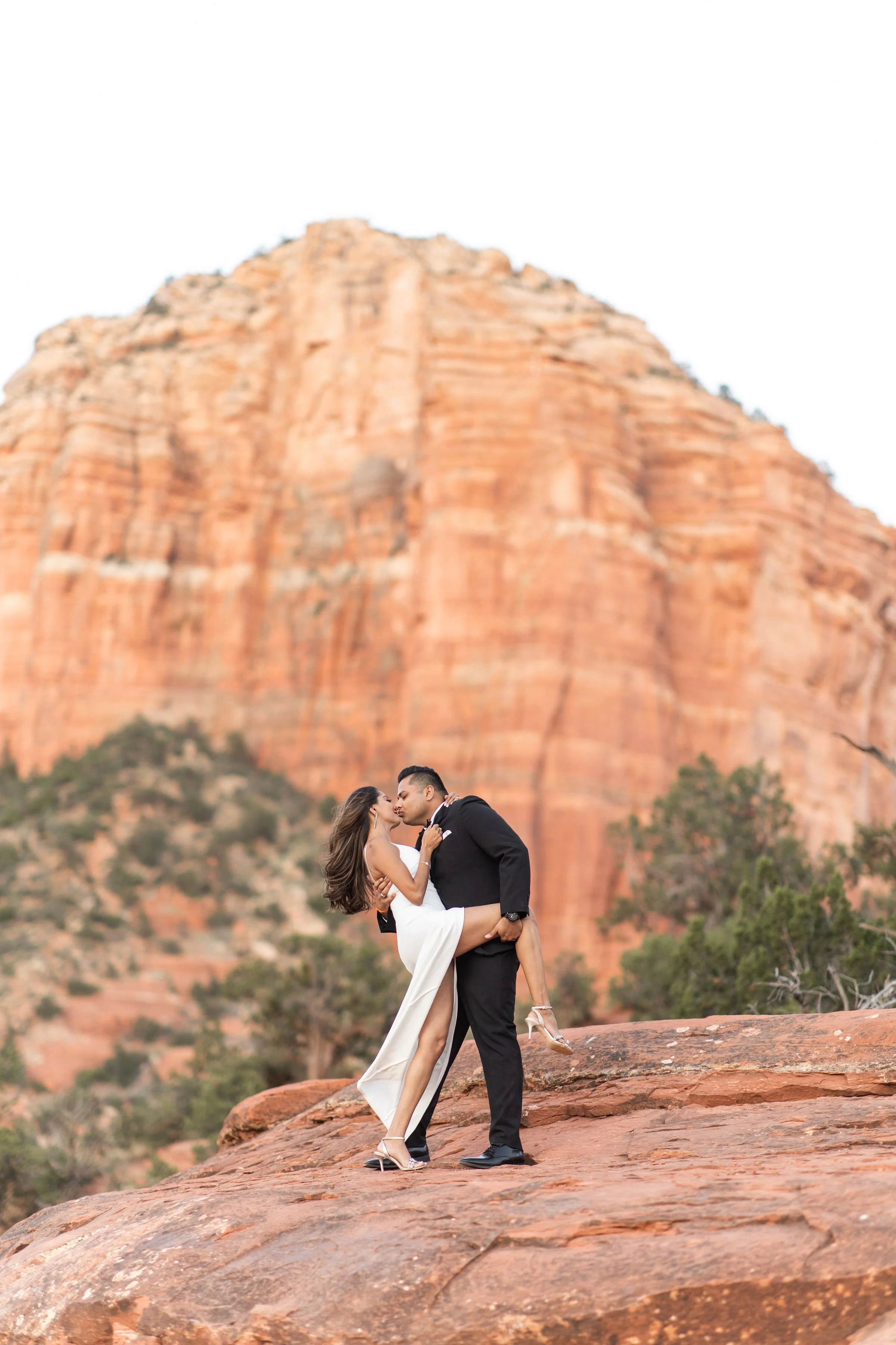 couple dipping at bell rock Sedona by Sedona elopement photographer Nick Patton
