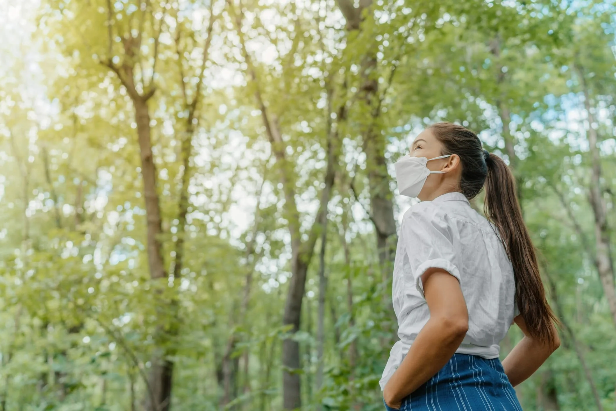 Woman wearing Face Mask with forest in the background
